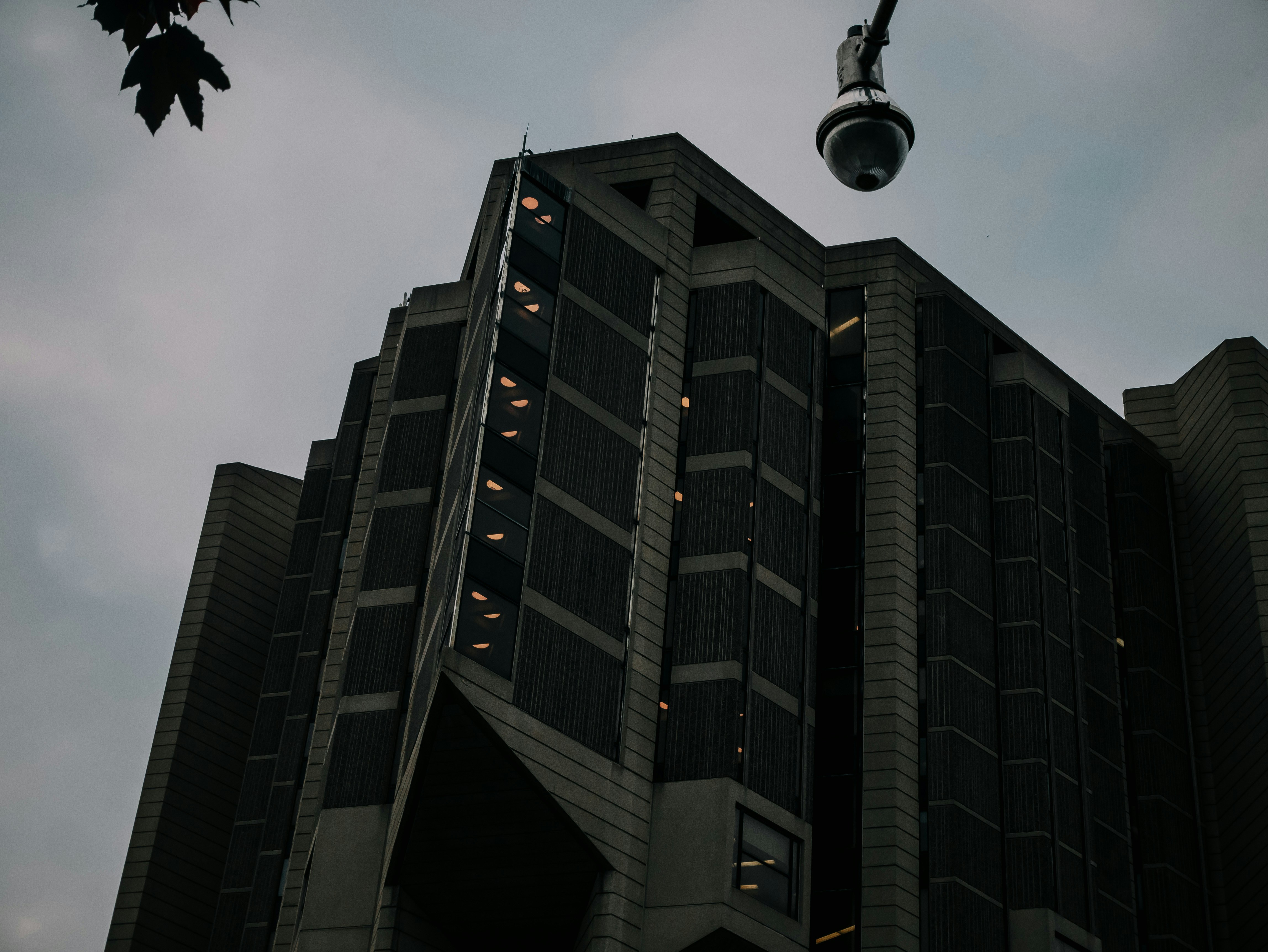Dark, ominous building with security camera overhead.