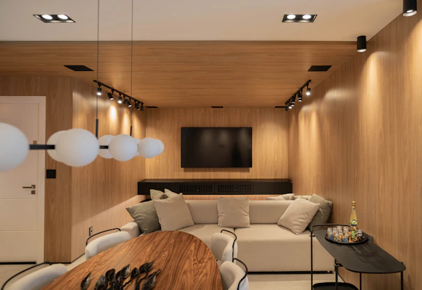 A modern living room with warm wood paneling