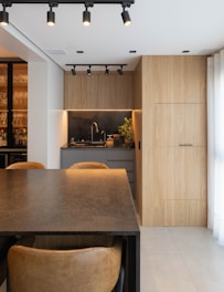 Modern kitchen with wooden cabinetry and sleek design.