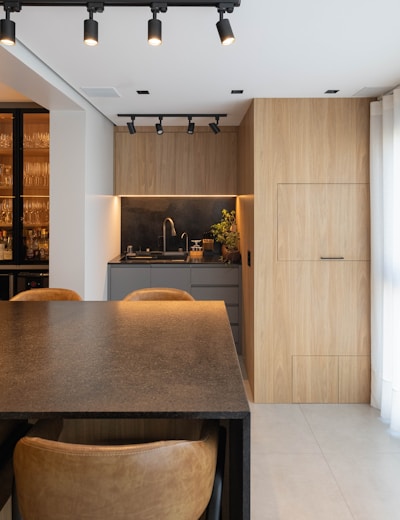 Modern kitchen with wooden cabinetry and sleek design.