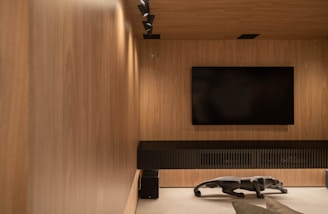 A modern entertainment room with wood paneling.