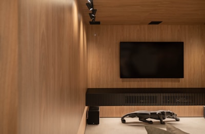 A modern entertainment room with wood paneling.