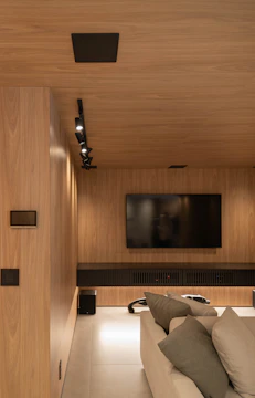 Modern media room with wooden paneling.