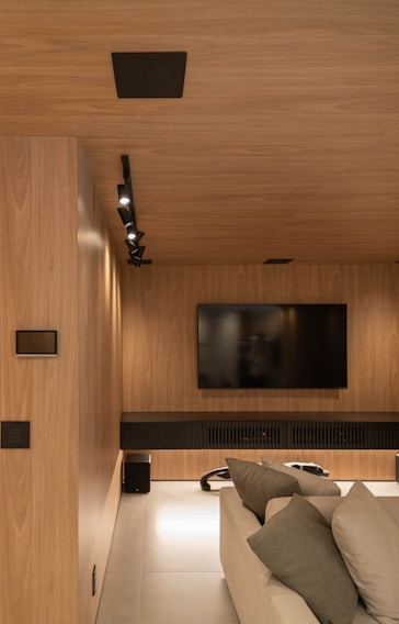 Modern media room with wooden paneling.