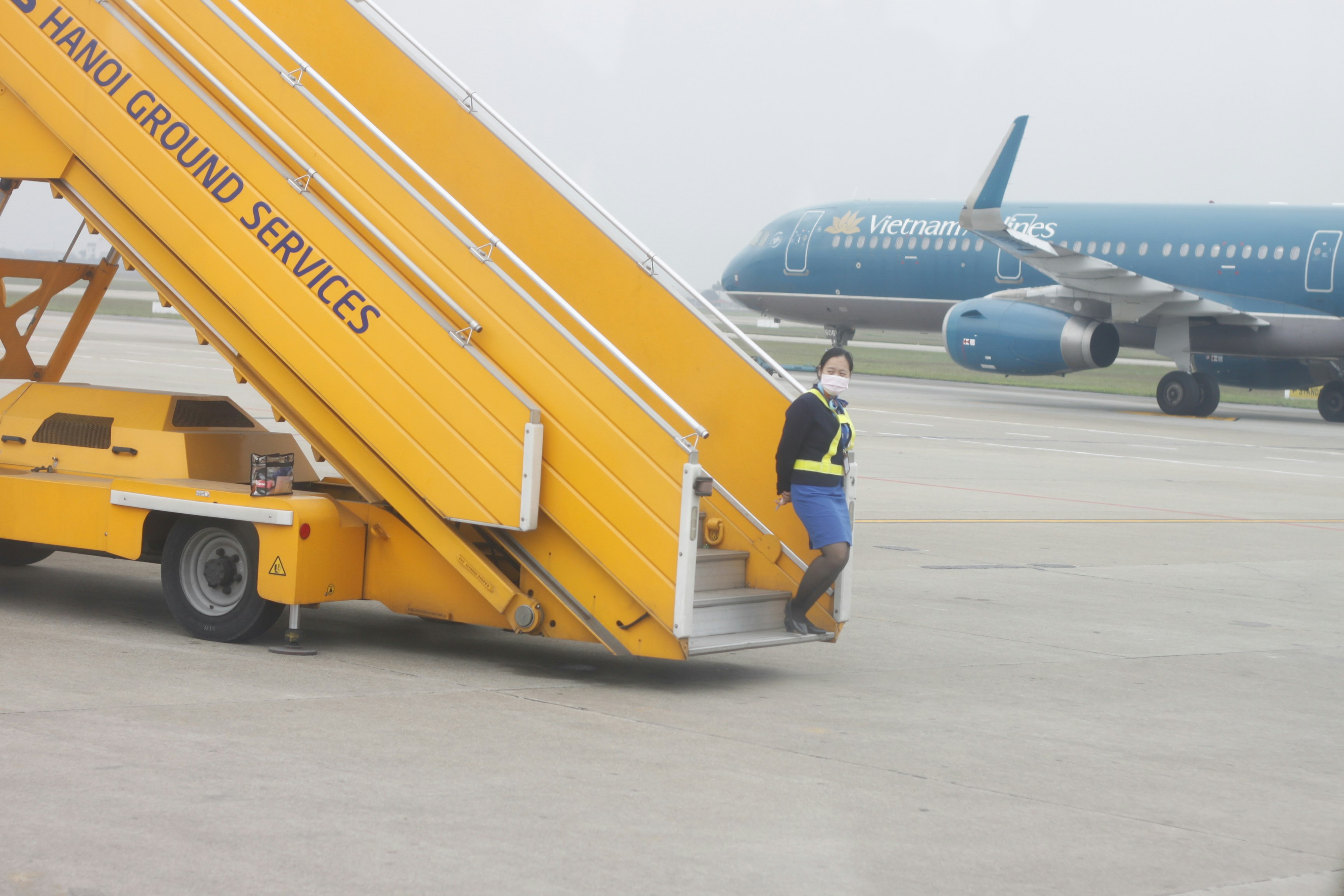 A ground crew member exits a mobile staircase.