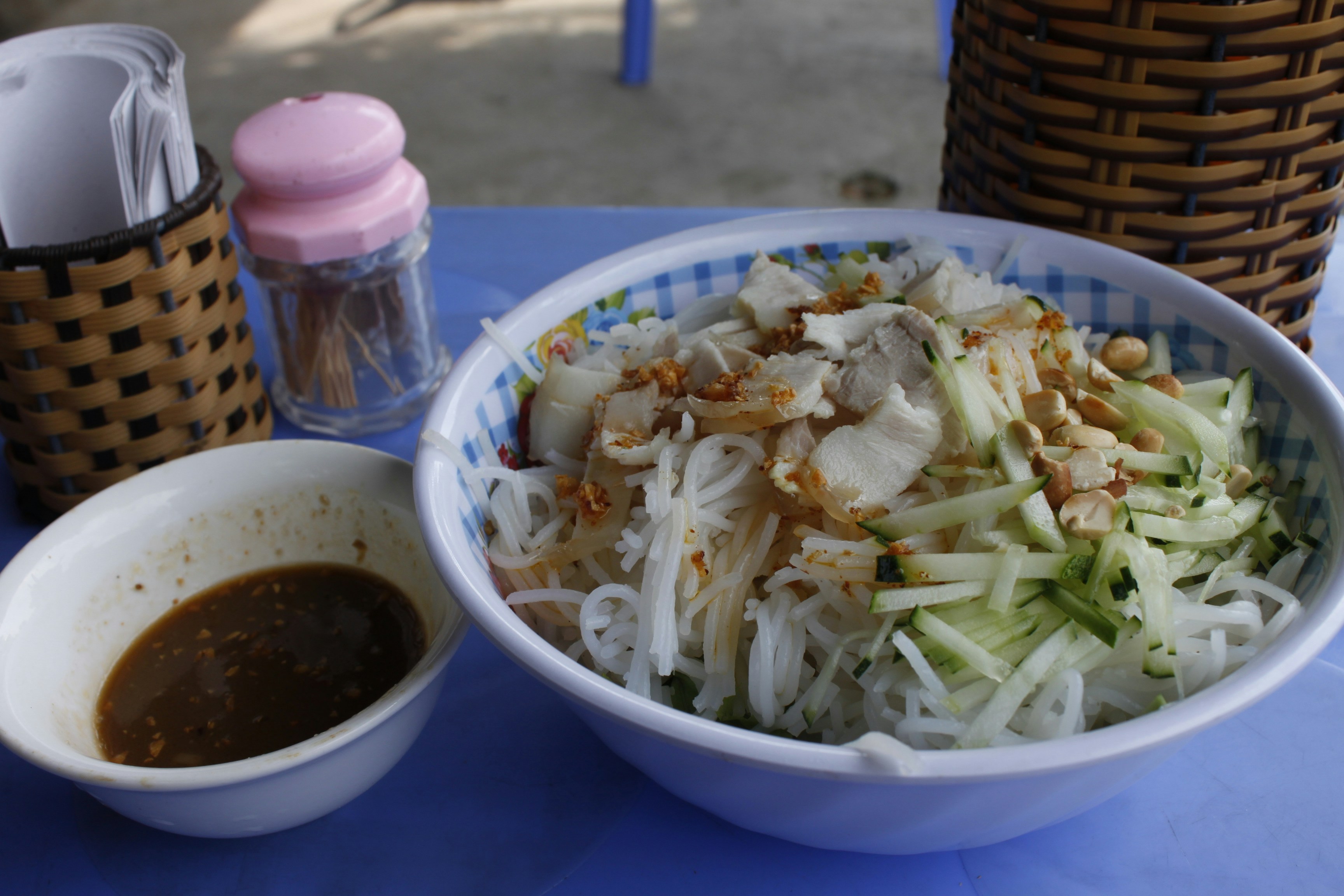 Rice noodles with a bowl of dipping sauce