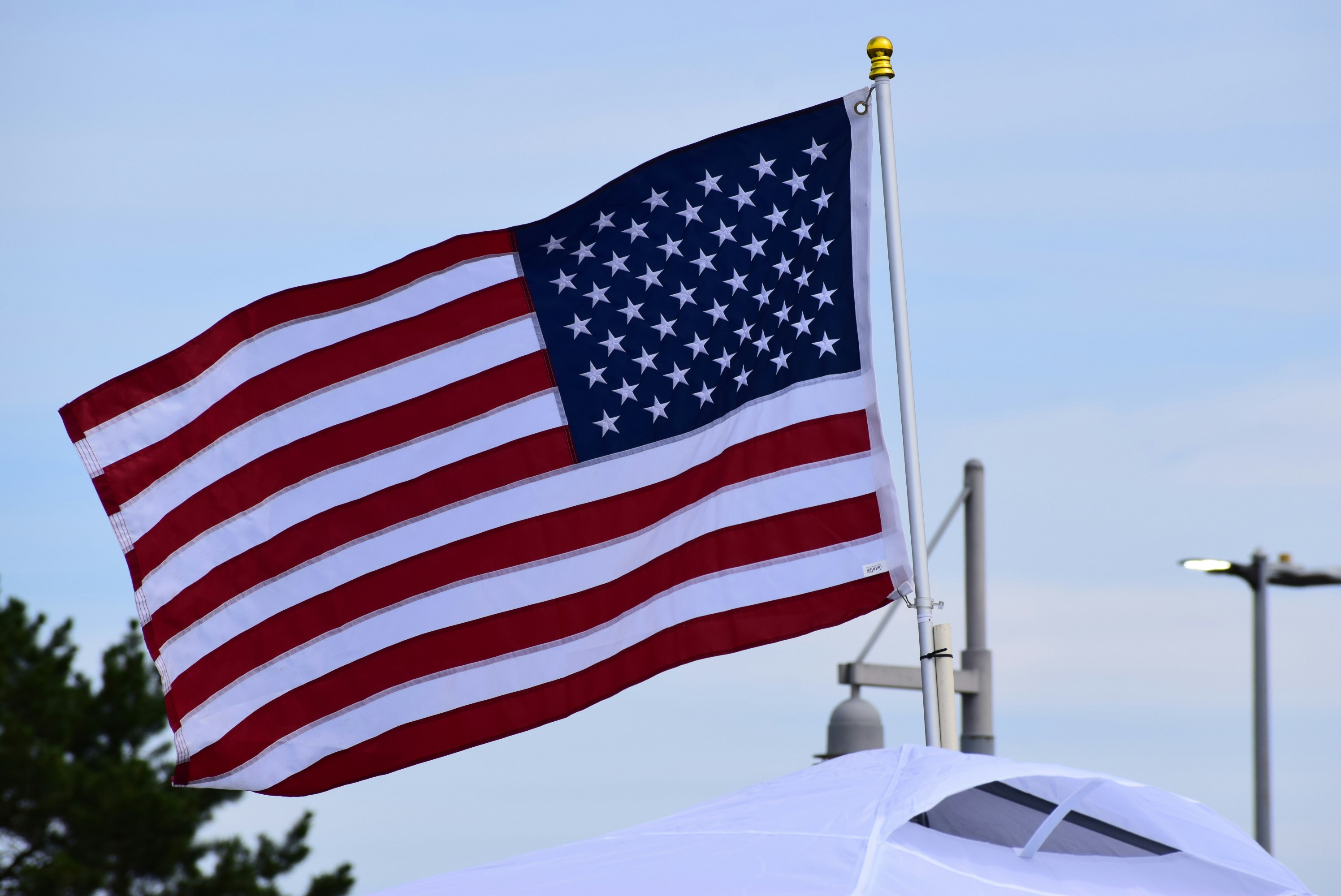 The american flag waves proudly in the wind.