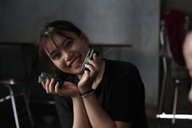 Smiling woman shows off delicious-looking food.