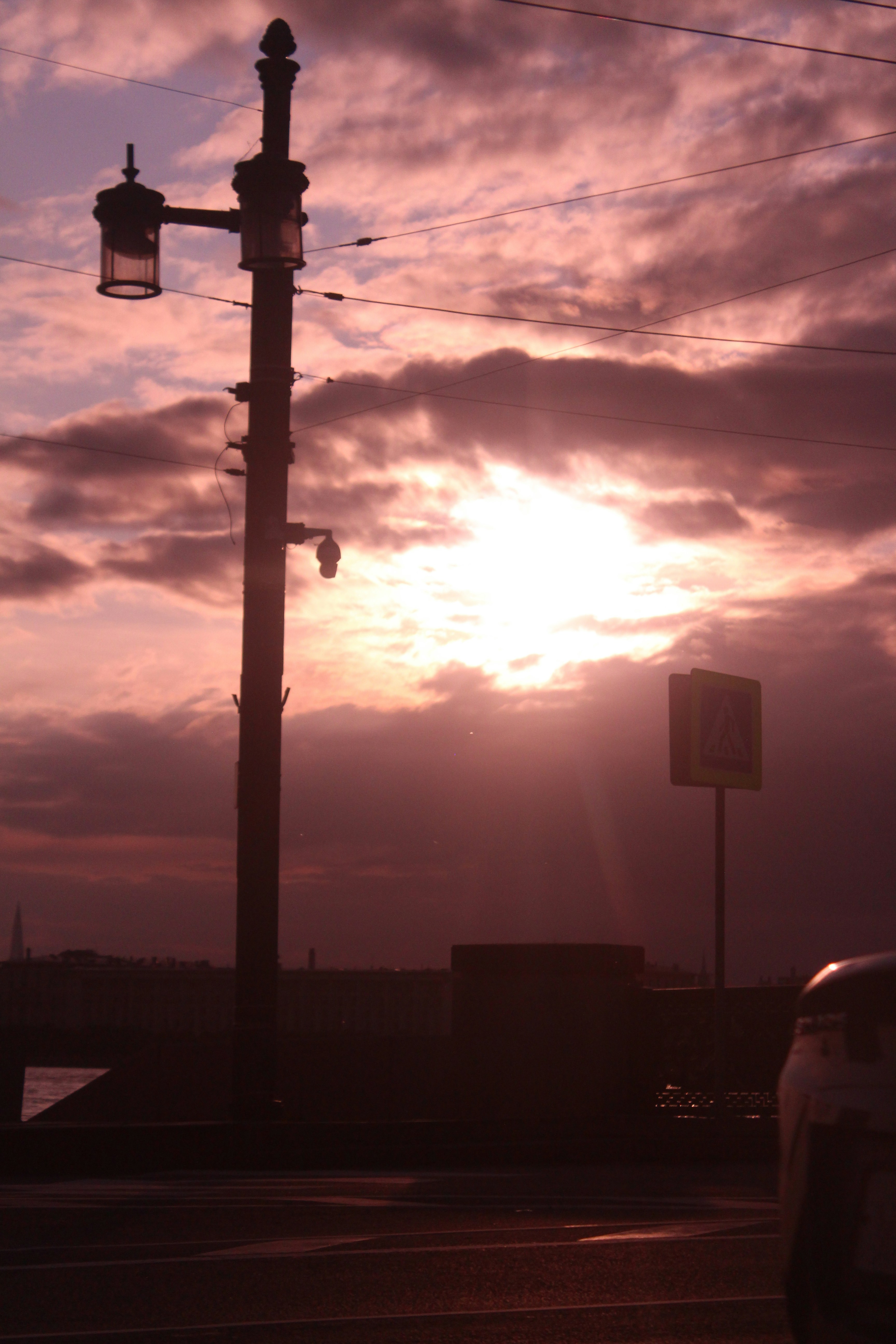 A silhouette of a lamppost and a sunset.