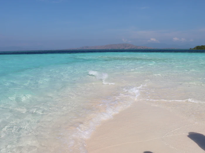Turquoise water meeting a white sand beach, similar to Culebra's Flamenco Beach
