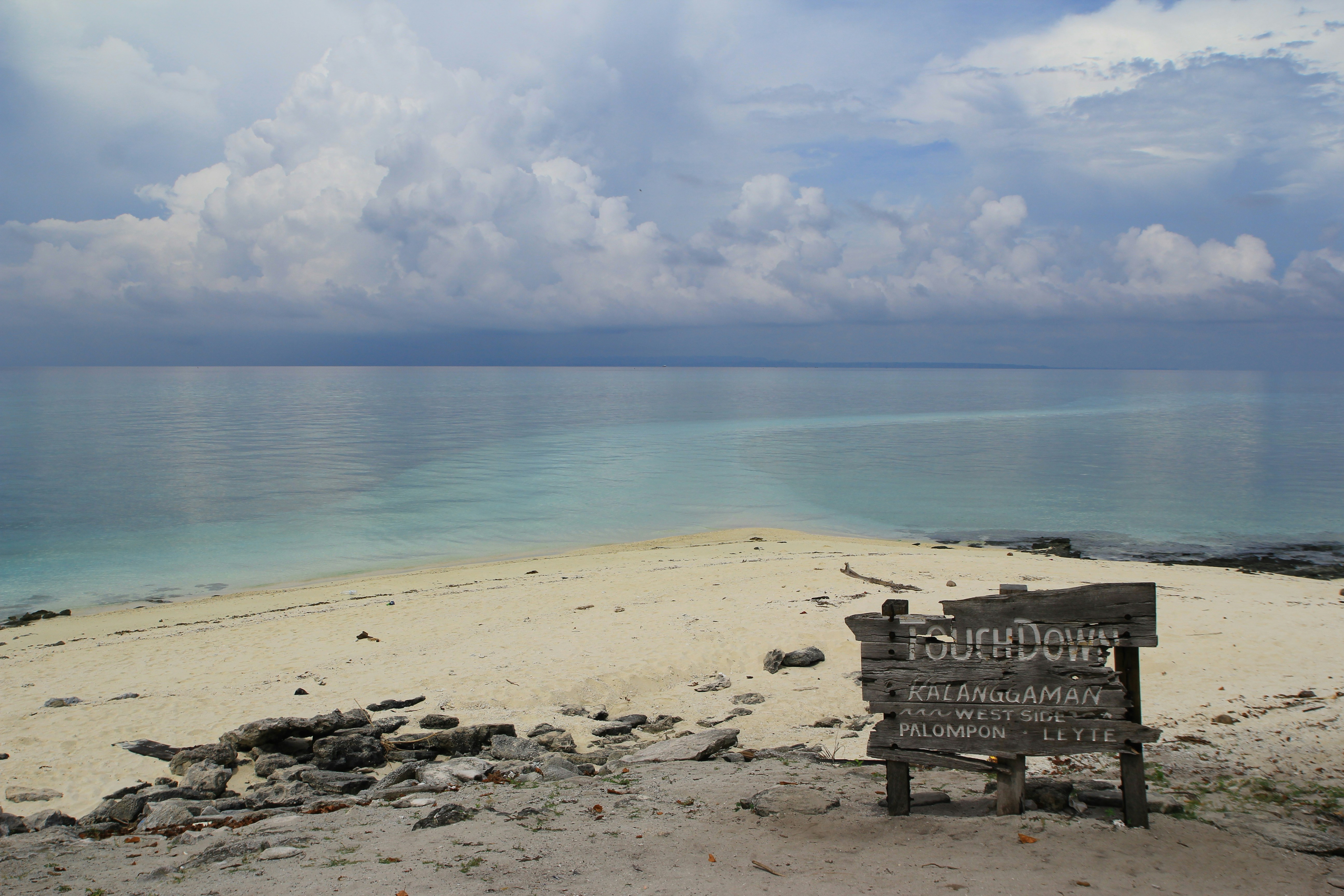 A serene beach scene under a dramatic sky.