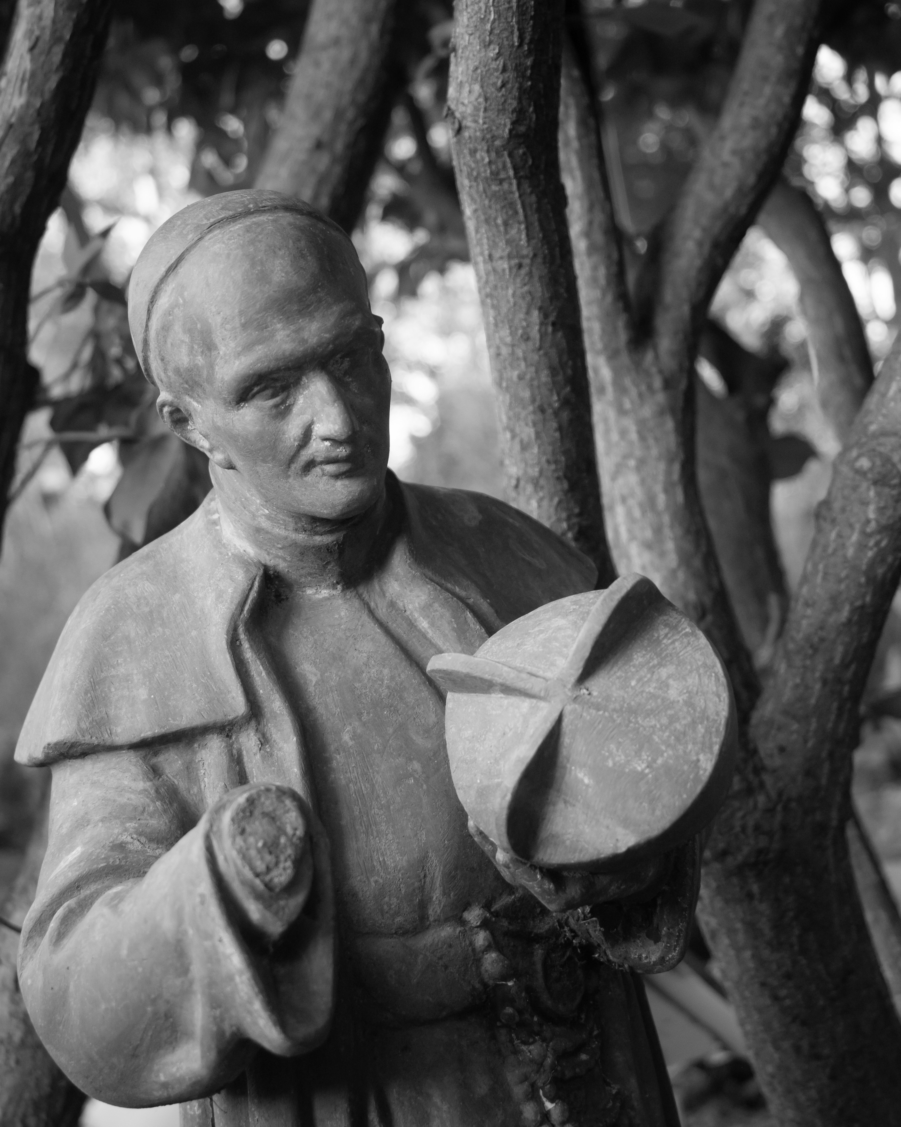 Statue of a religious figure holding a hat.