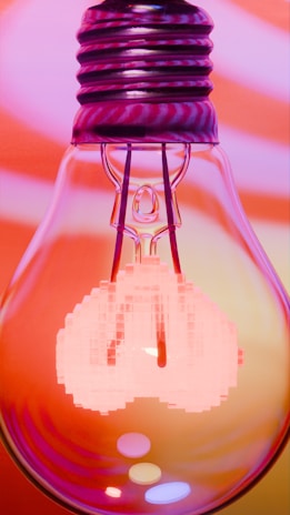 A glowing light bulb with pixelated elements.