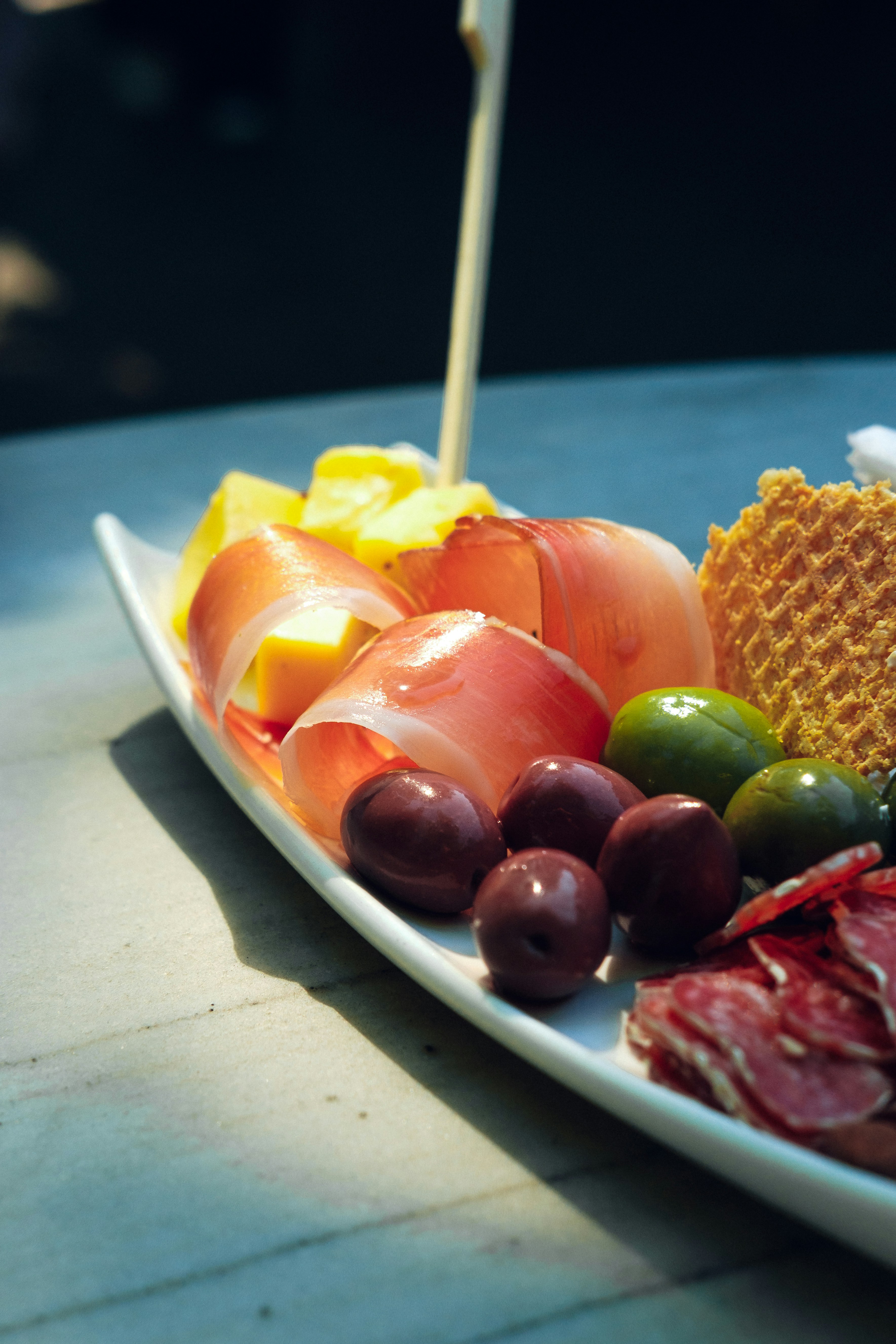 Mediterranean snack recipes with hummus, vegetables, and olives on a small plate
