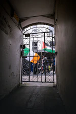 View through a gate and archway with irish flags.