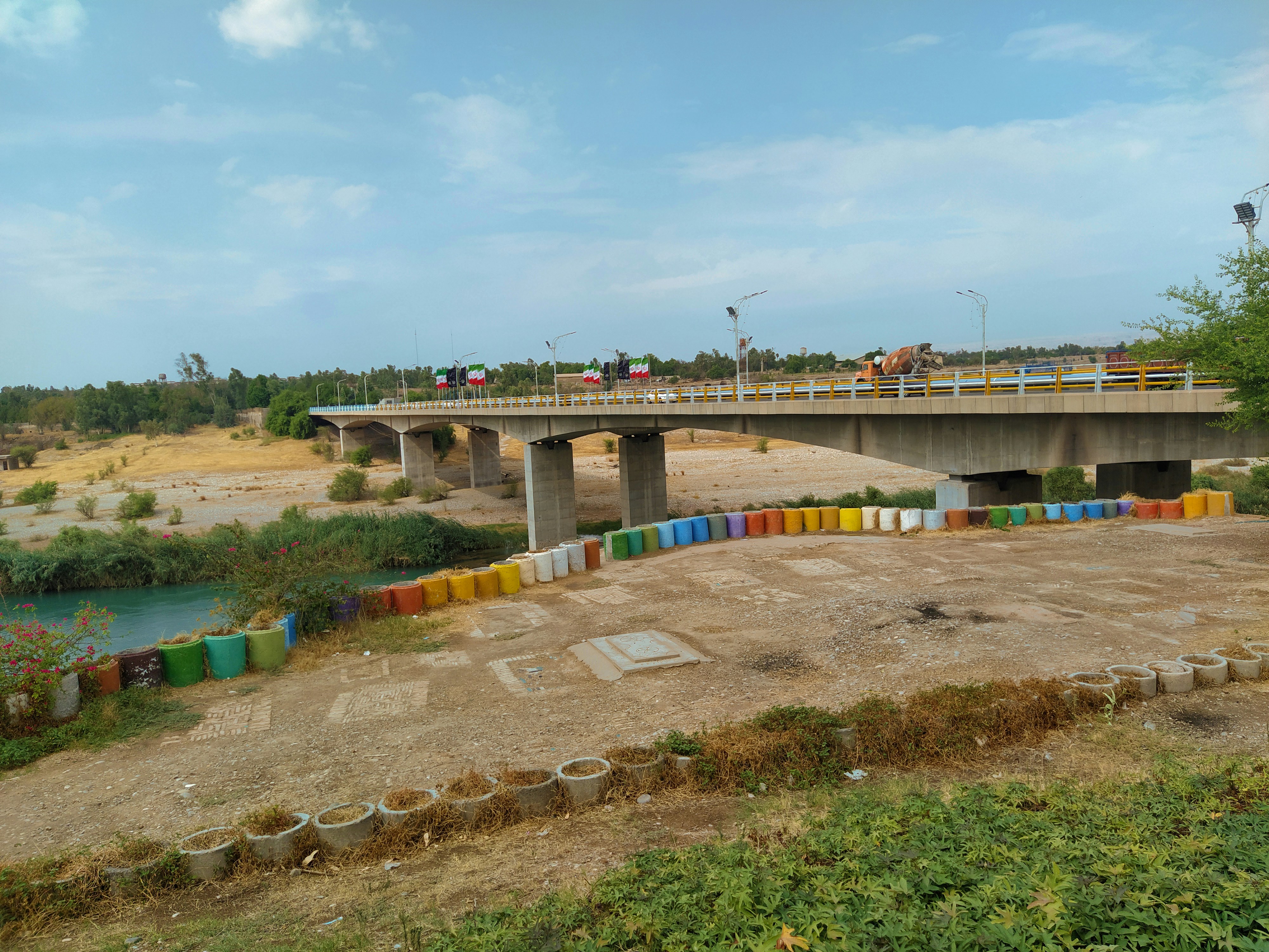 A bridge crosses over a dry riverbed