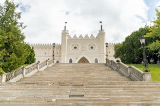 Steps lead up to a beautiful white building.