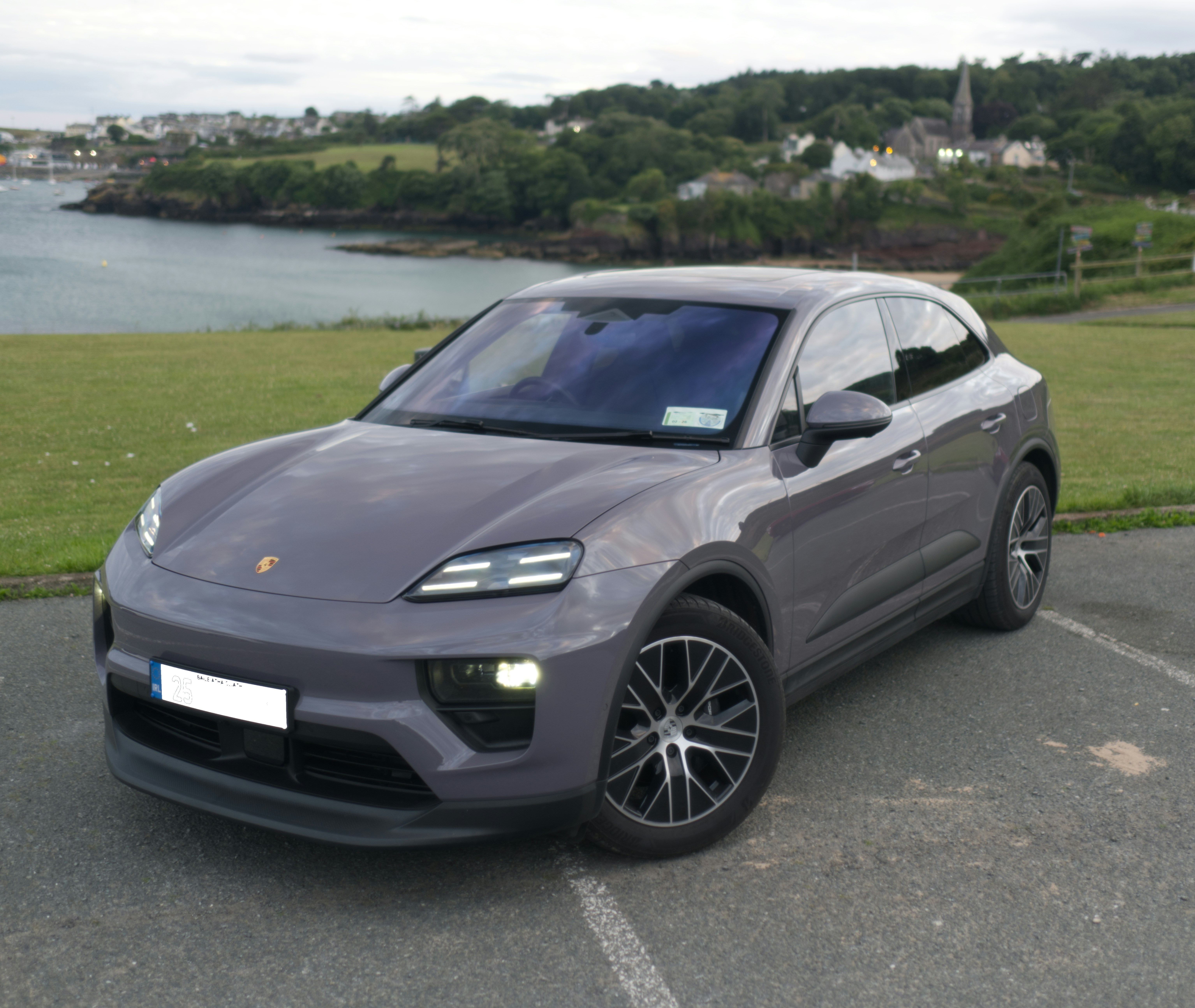 A grey porsche suv is parked outdoors.