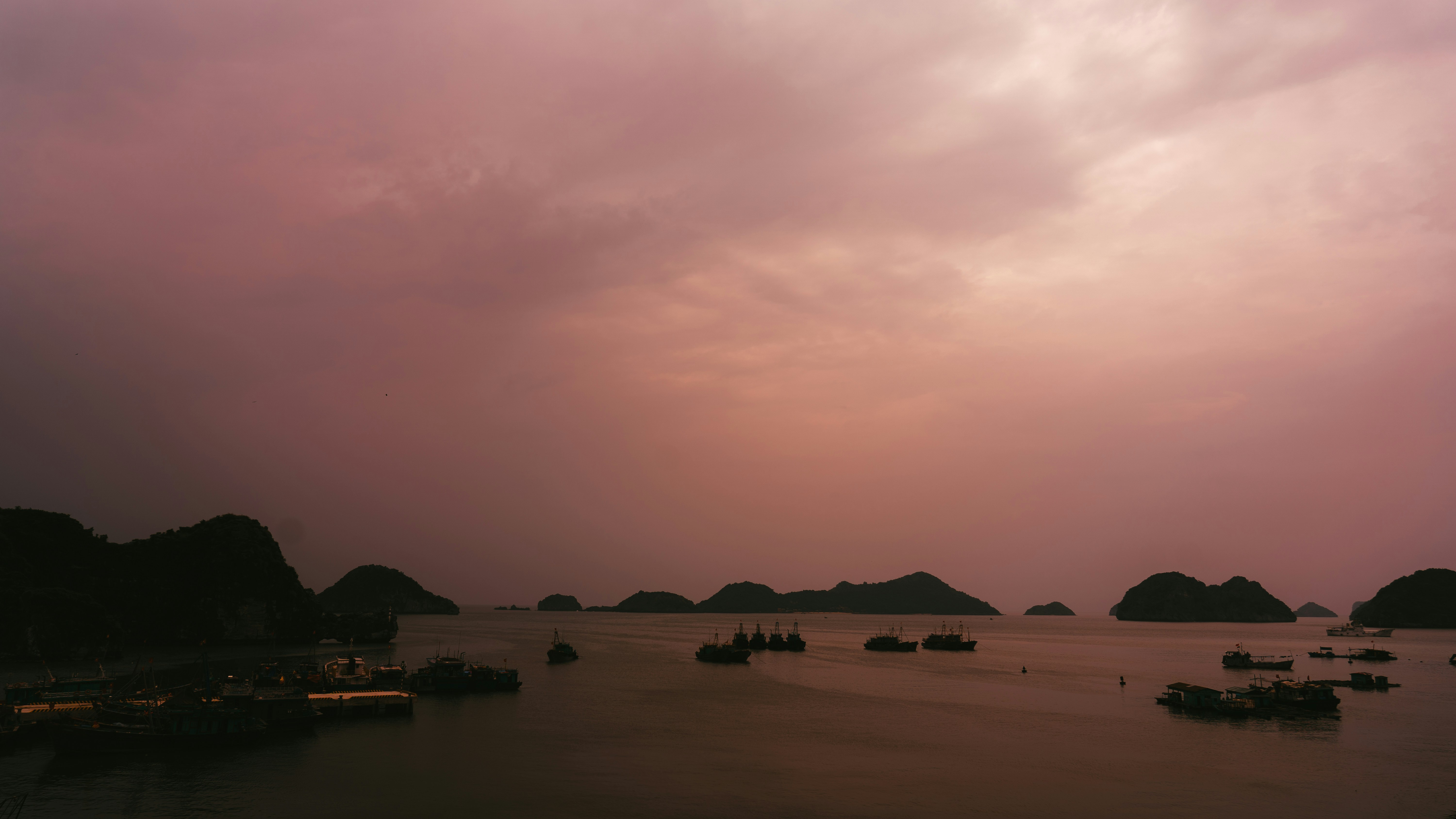 A dark pink sky over water and islands.
