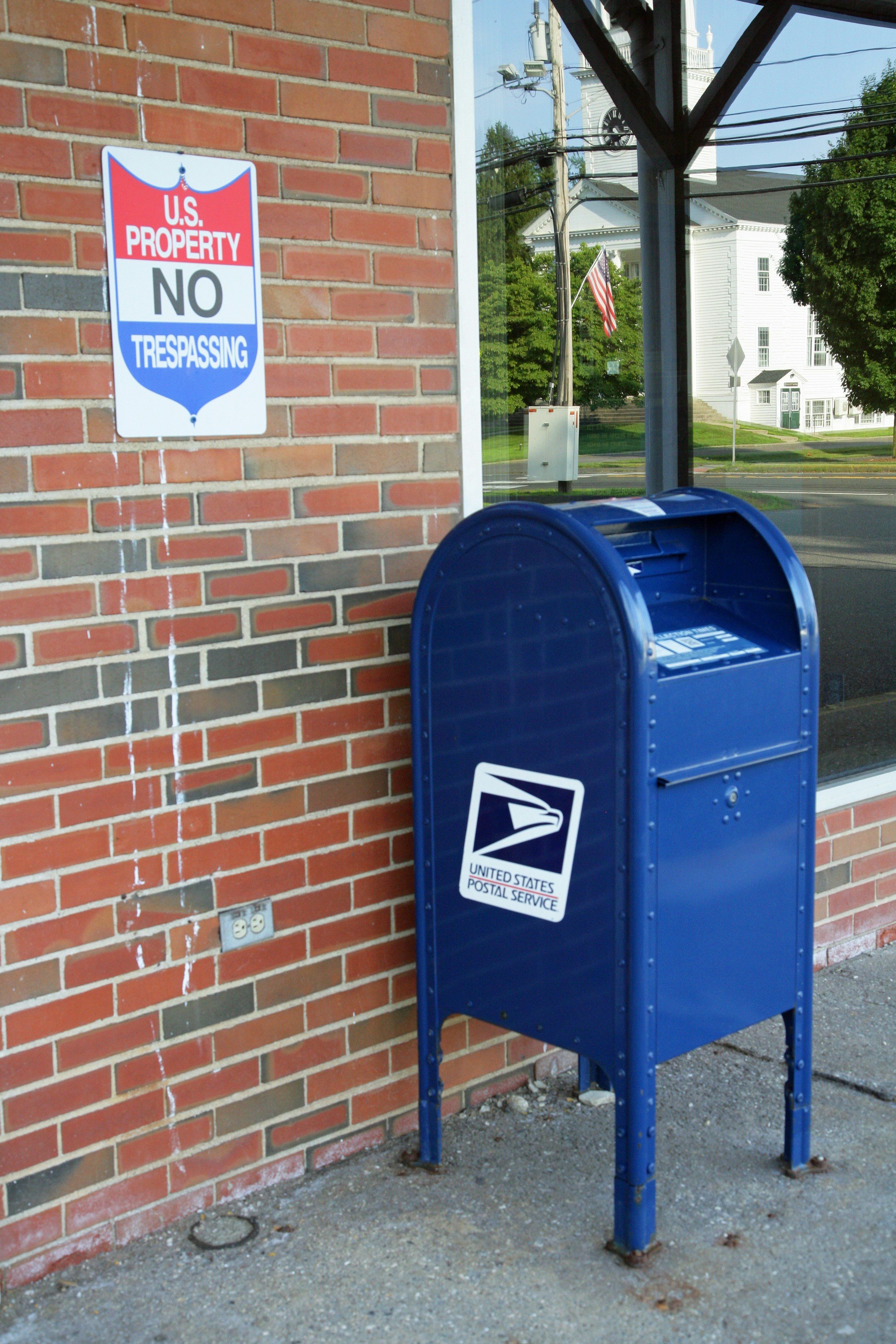 A u.s. mailbox and no trespassing sign.
