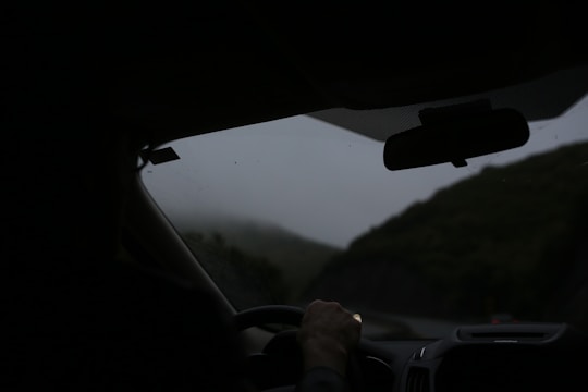 Driving through the misty mountains in a car.