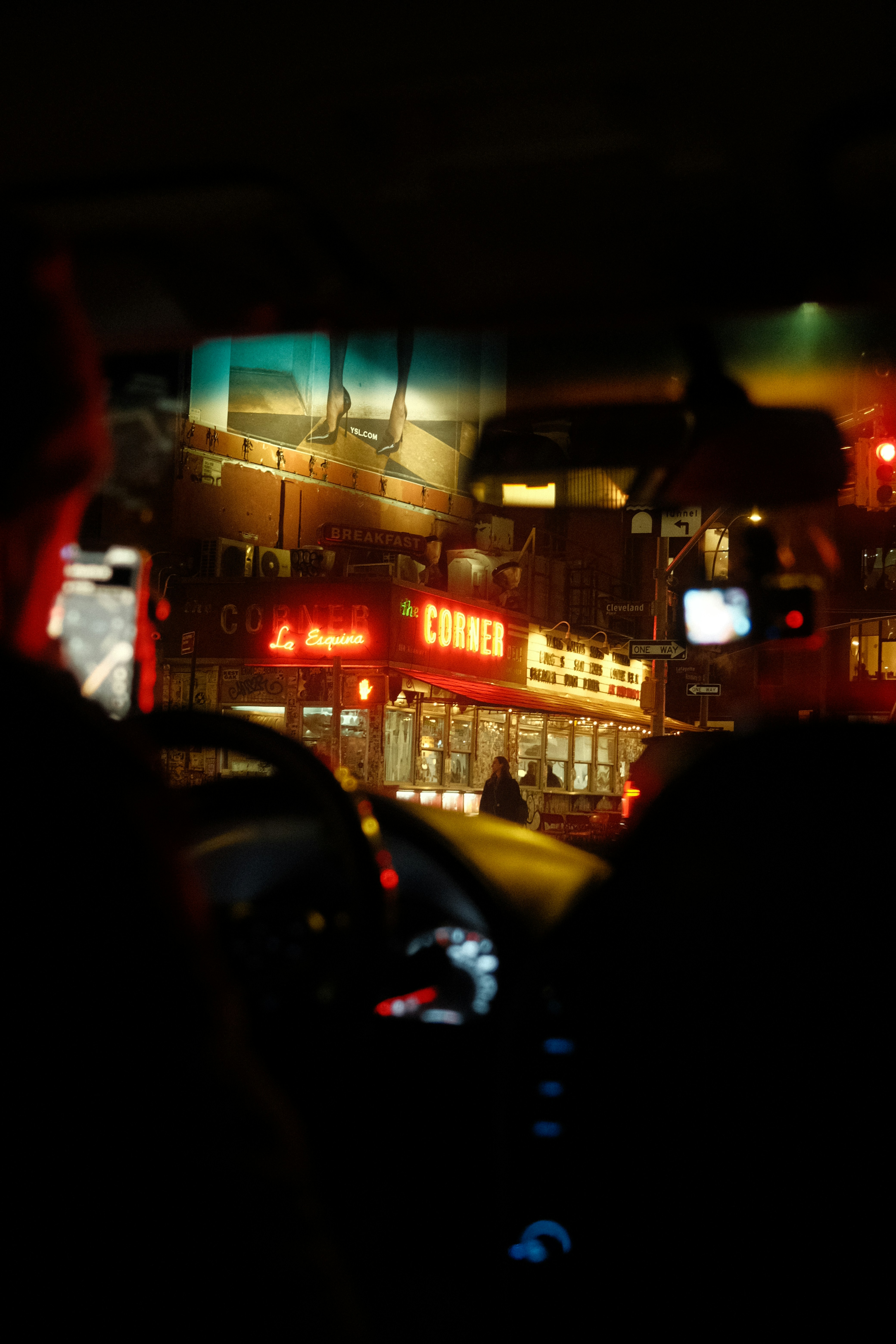 Nighttime view from inside a car toward a restaurant