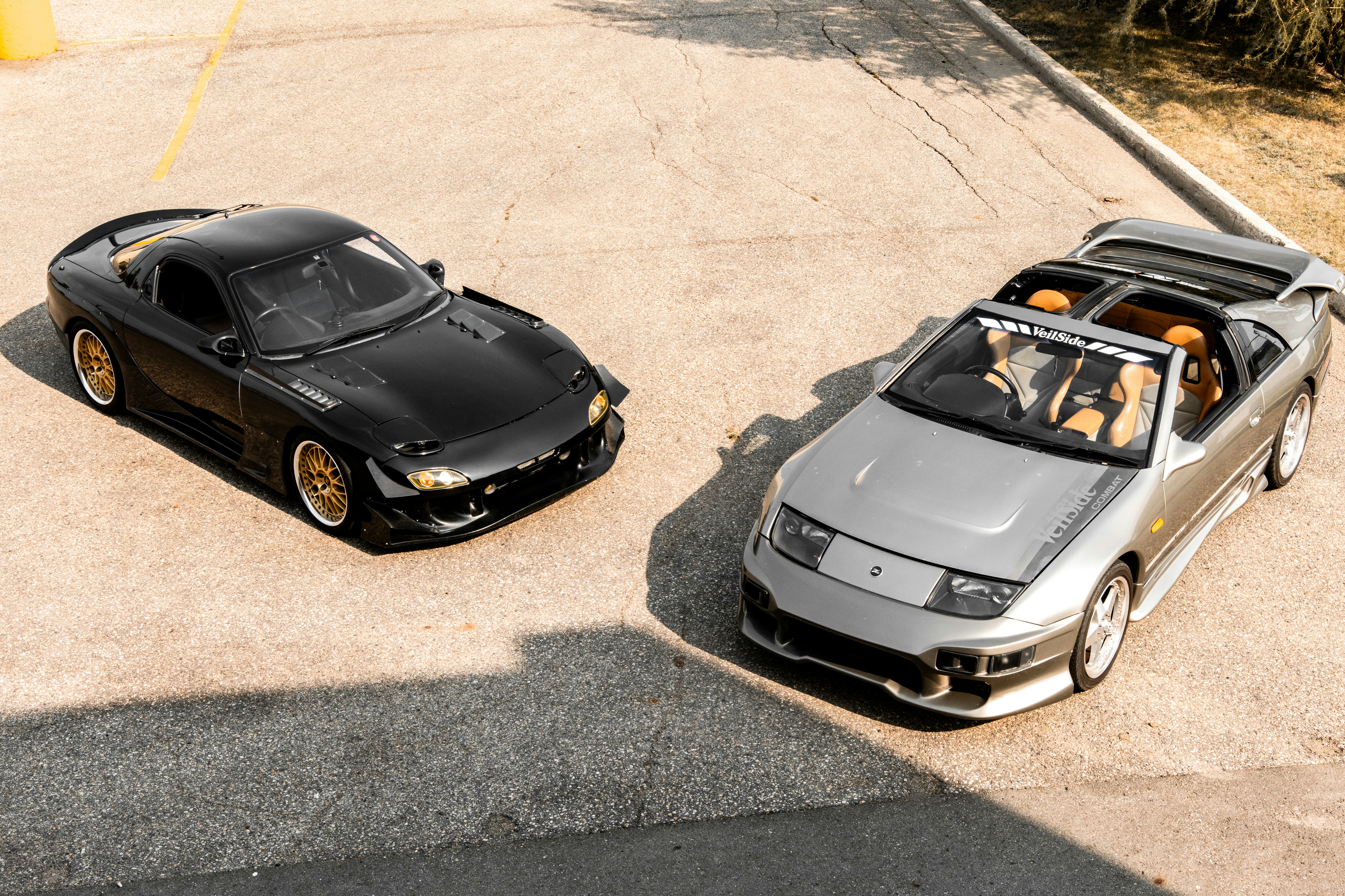 Two classic sports cars parked side by side.