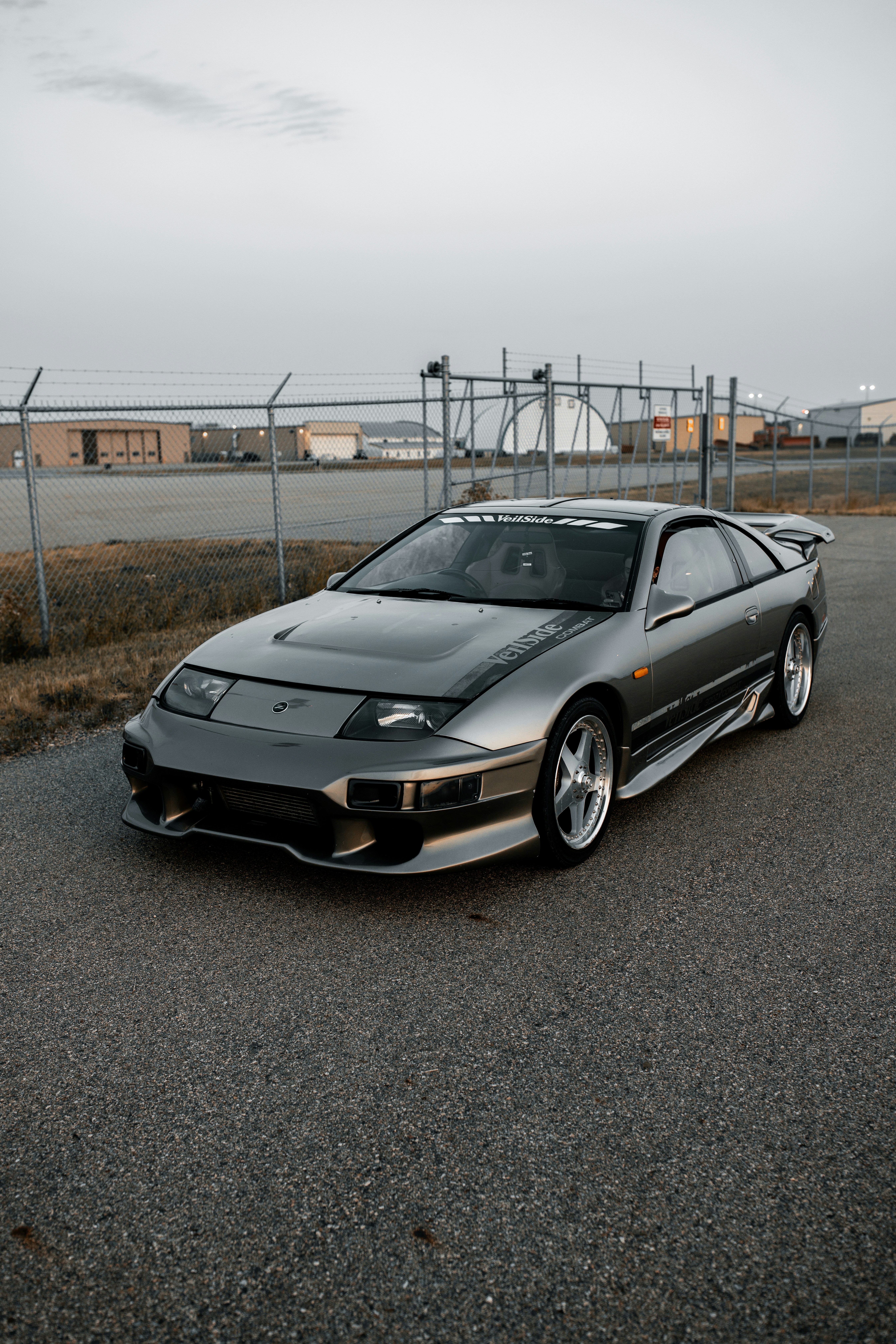 A gray sports car is parked on the road.