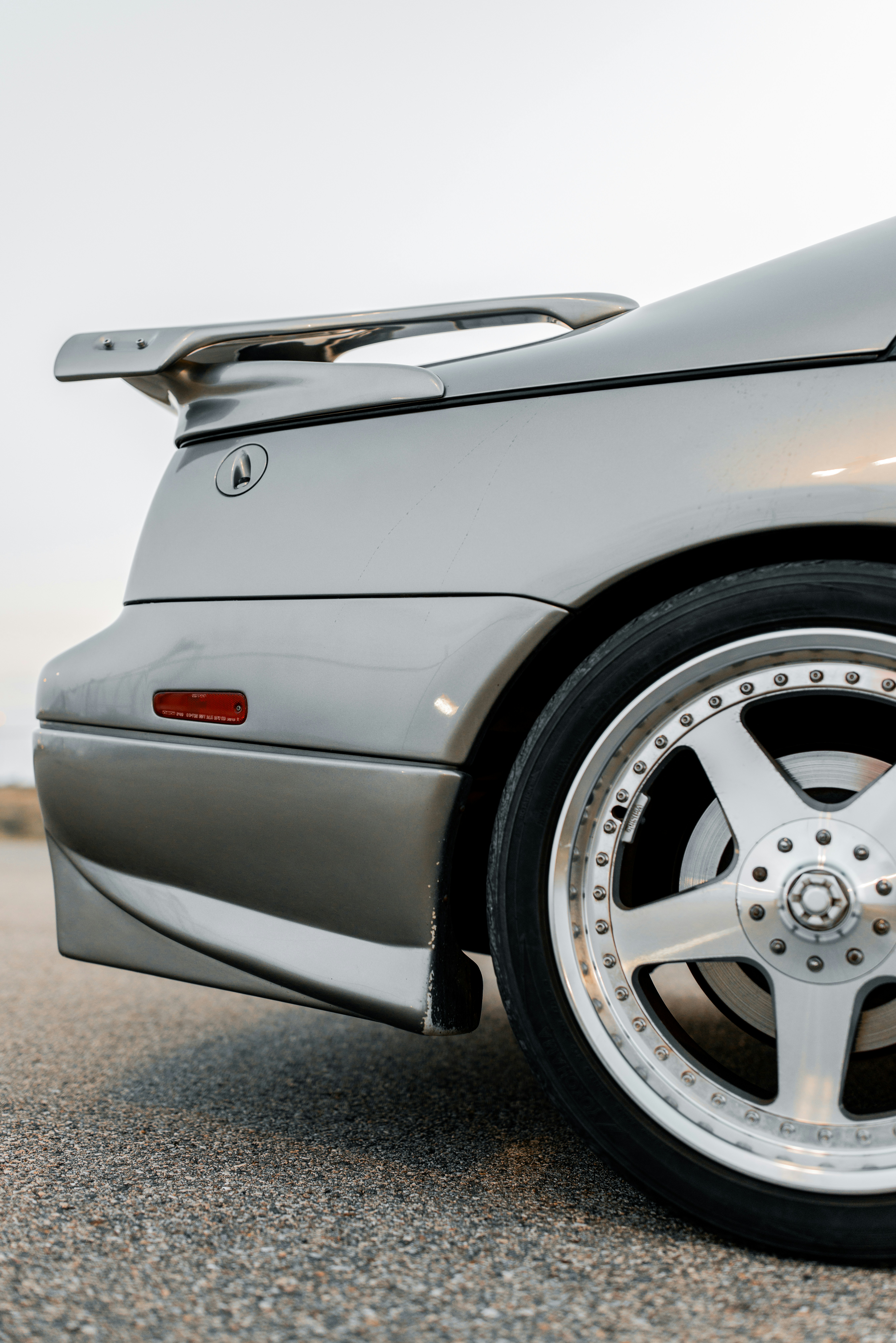 A silver sports car's rear section.