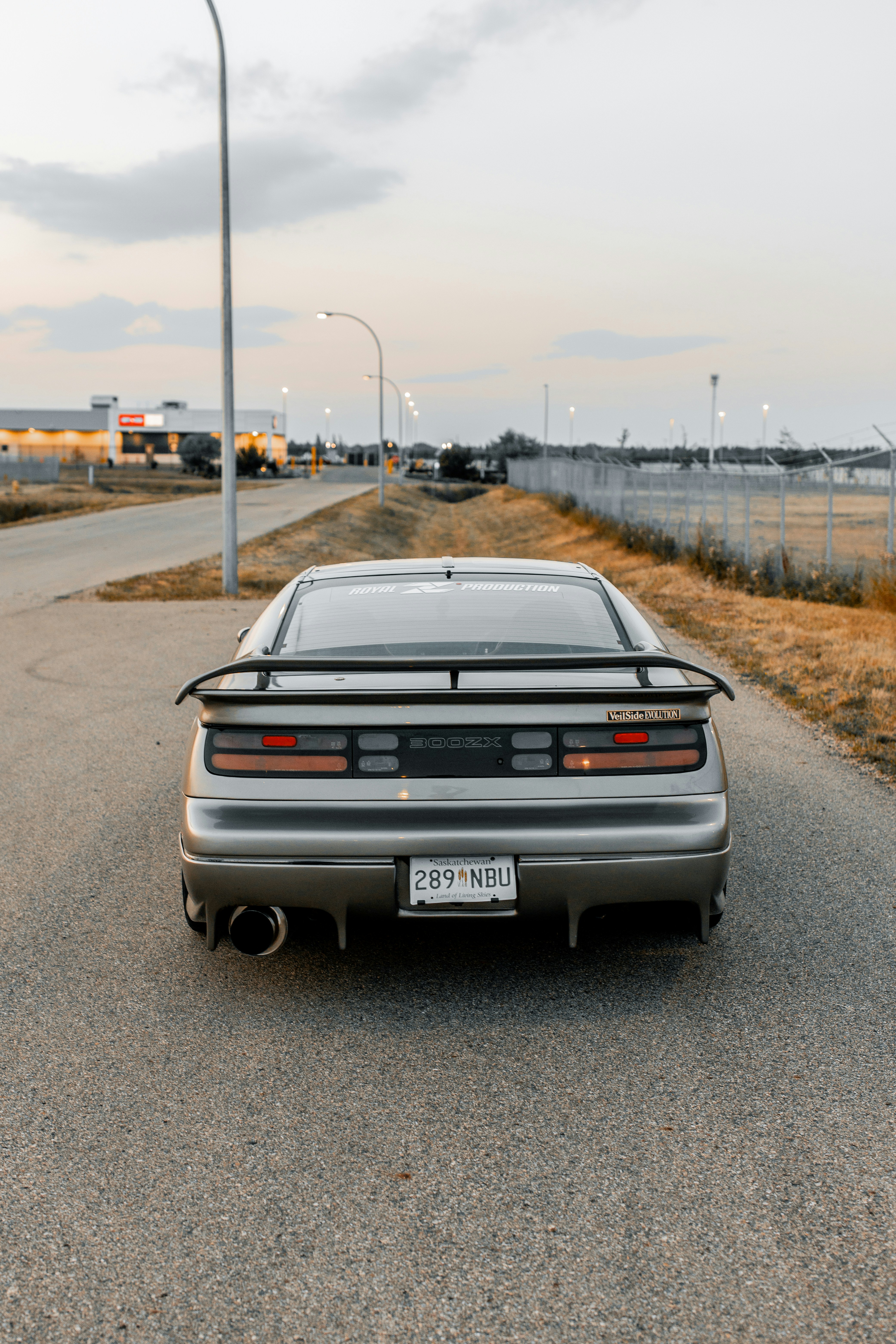 A gray car is parked on the road.