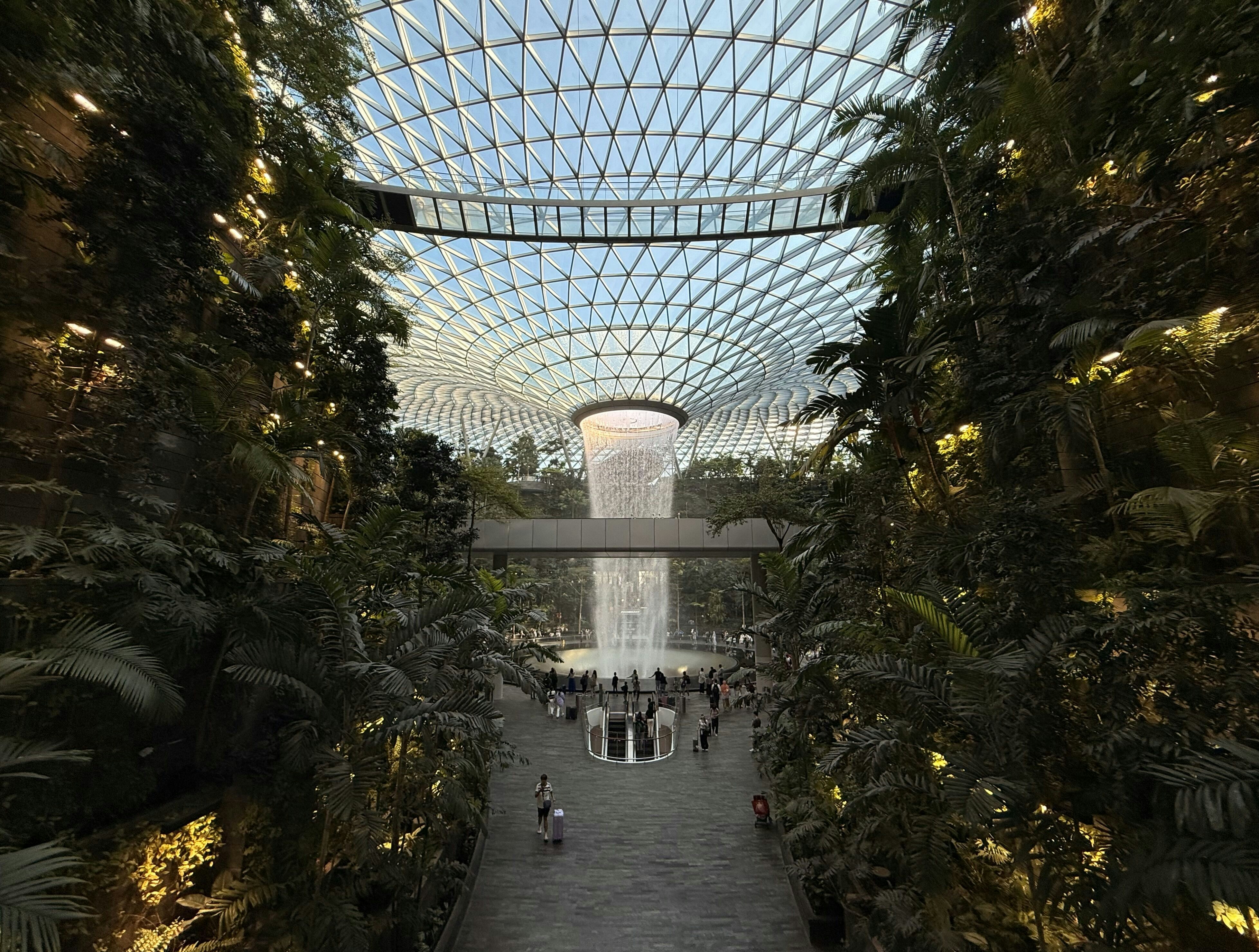 A beautiful indoor waterfall with a glass dome.