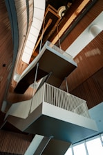 An architectural interior features suspended staircases.