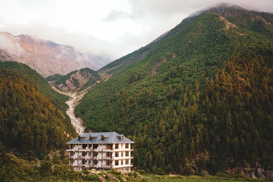 A house nestled amongst gorgeous green mountains.