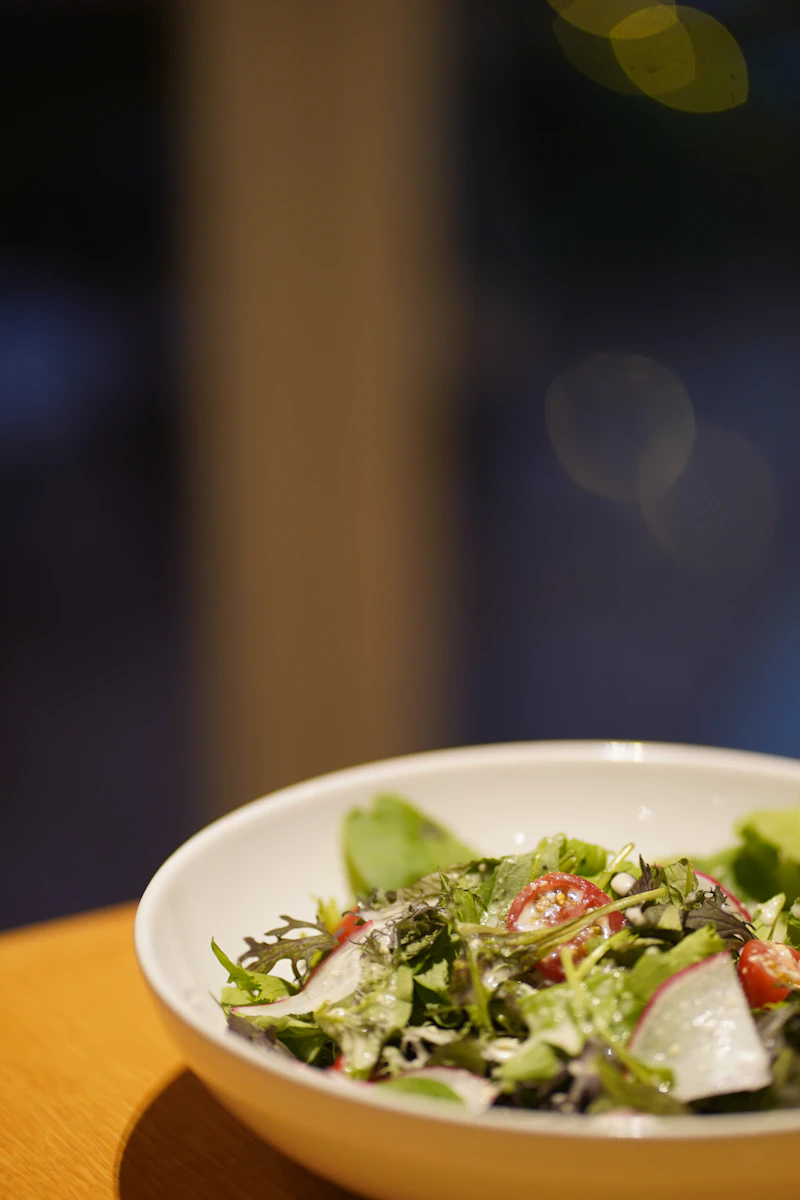 Fresh greens salad plated in a restaurant bowl