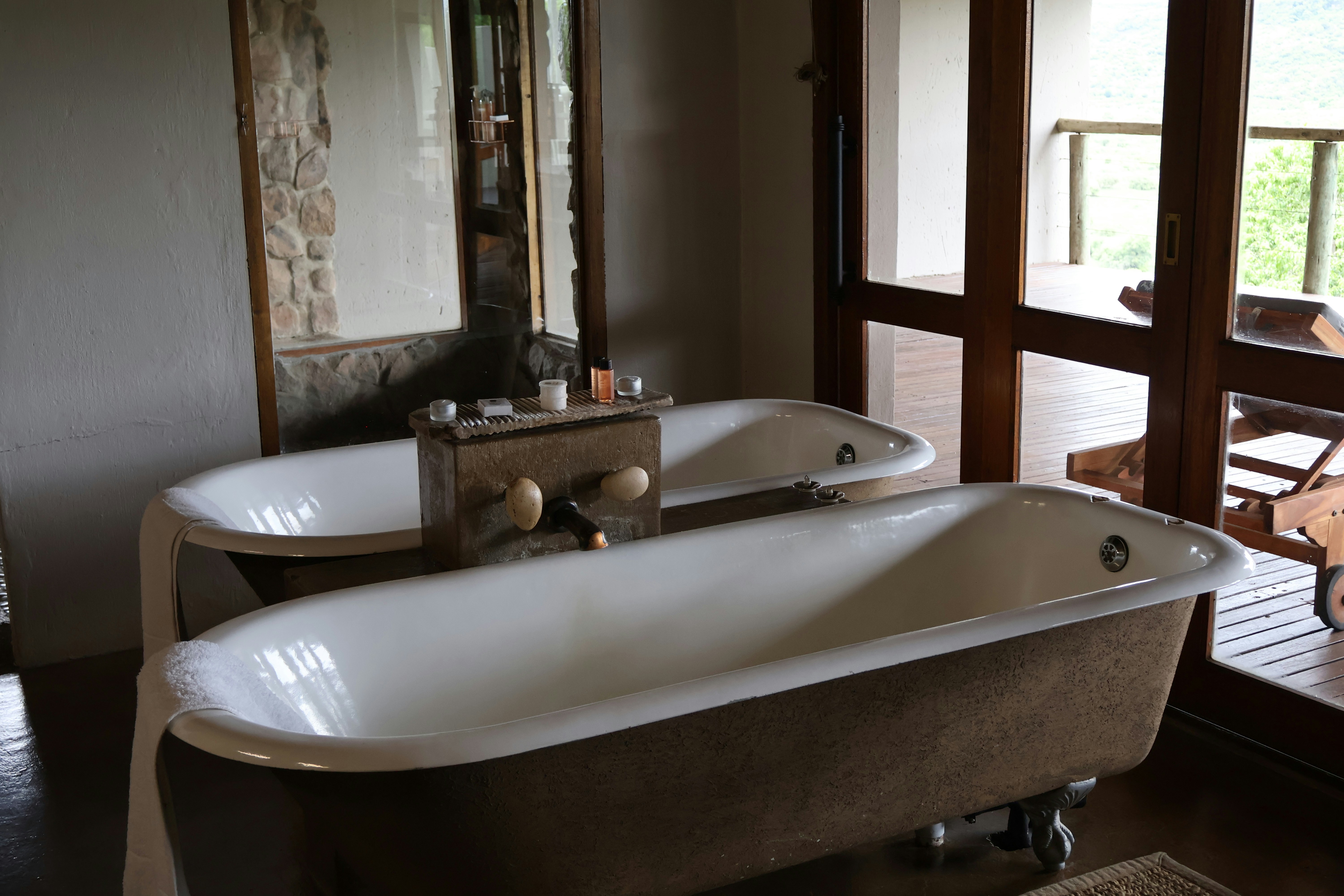 Two bathtubs sit inside a spacious bathroom.