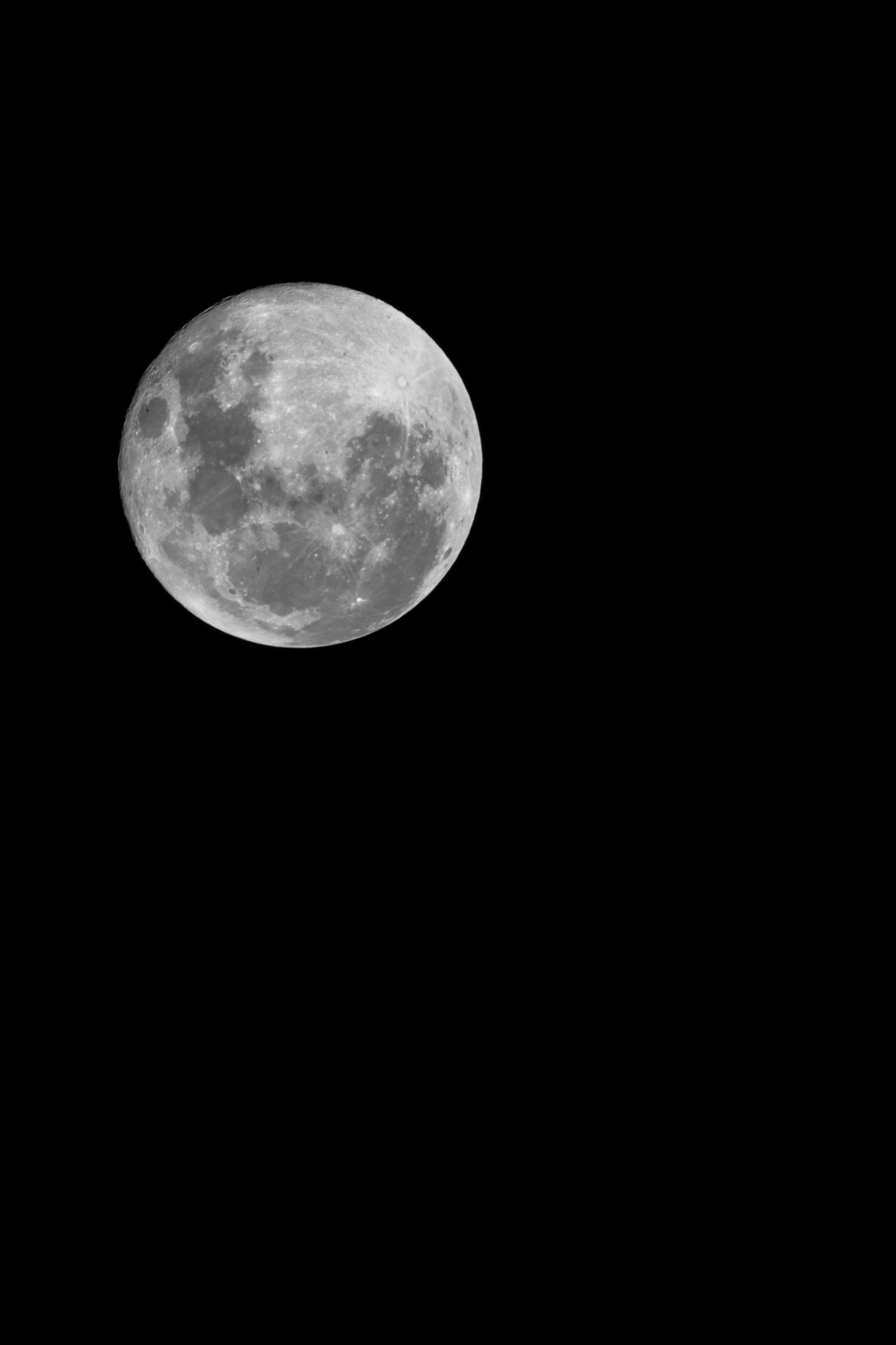 A bright full moon in the black sky.