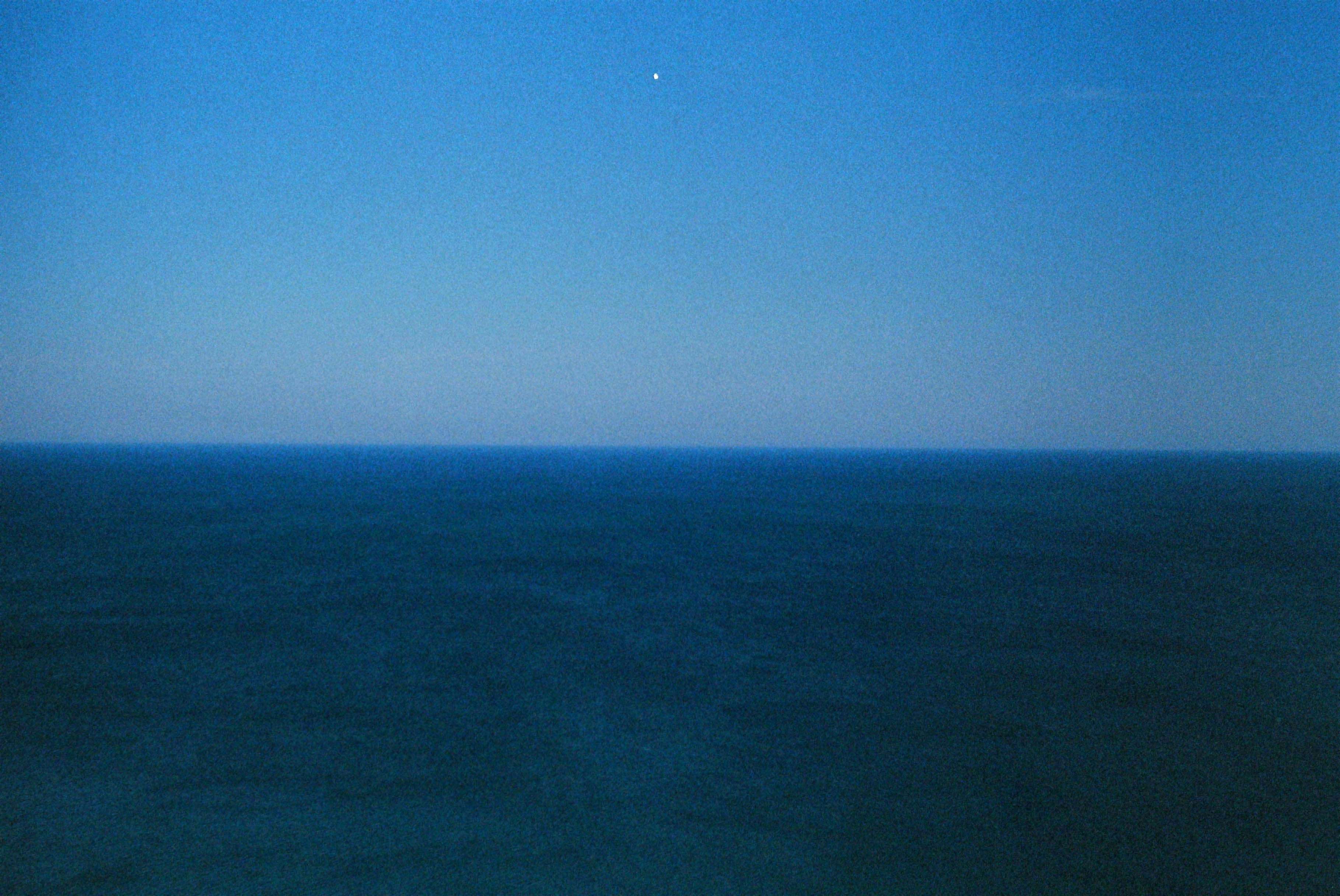 An open sea with a clear sky.