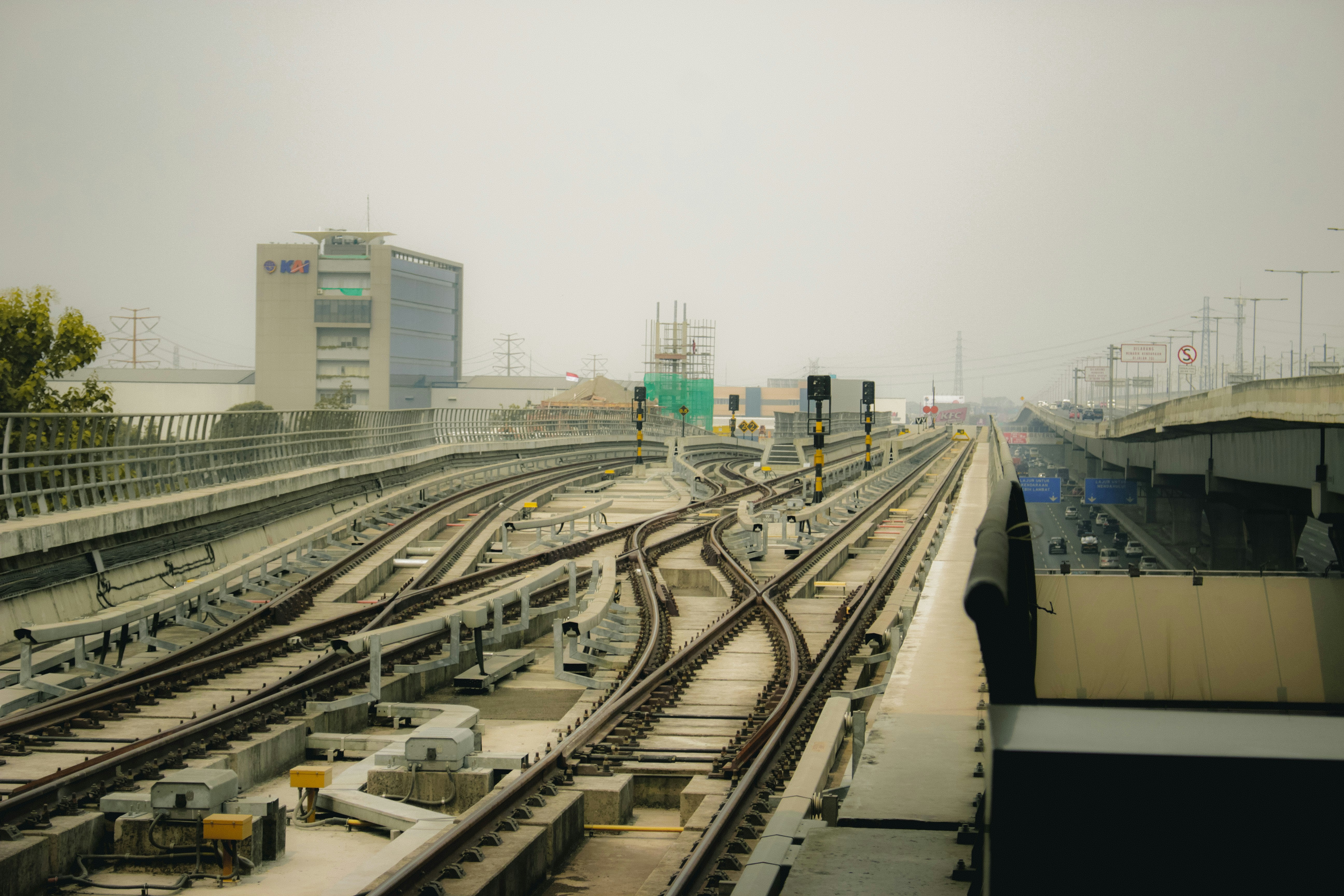 Railway tracks and buildings are visible in the shot.