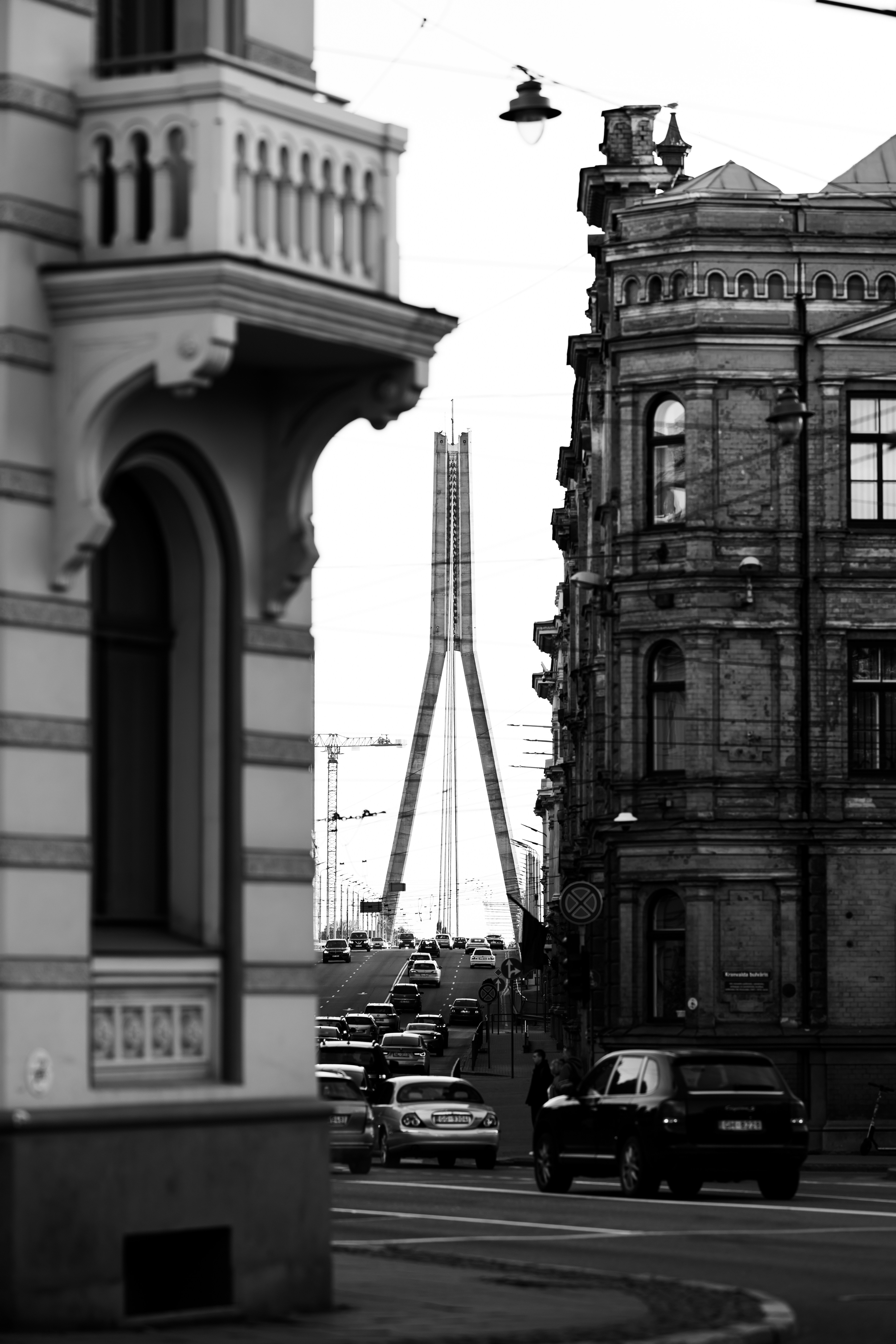 Buildings frame the view of the city's bridge and traffic.