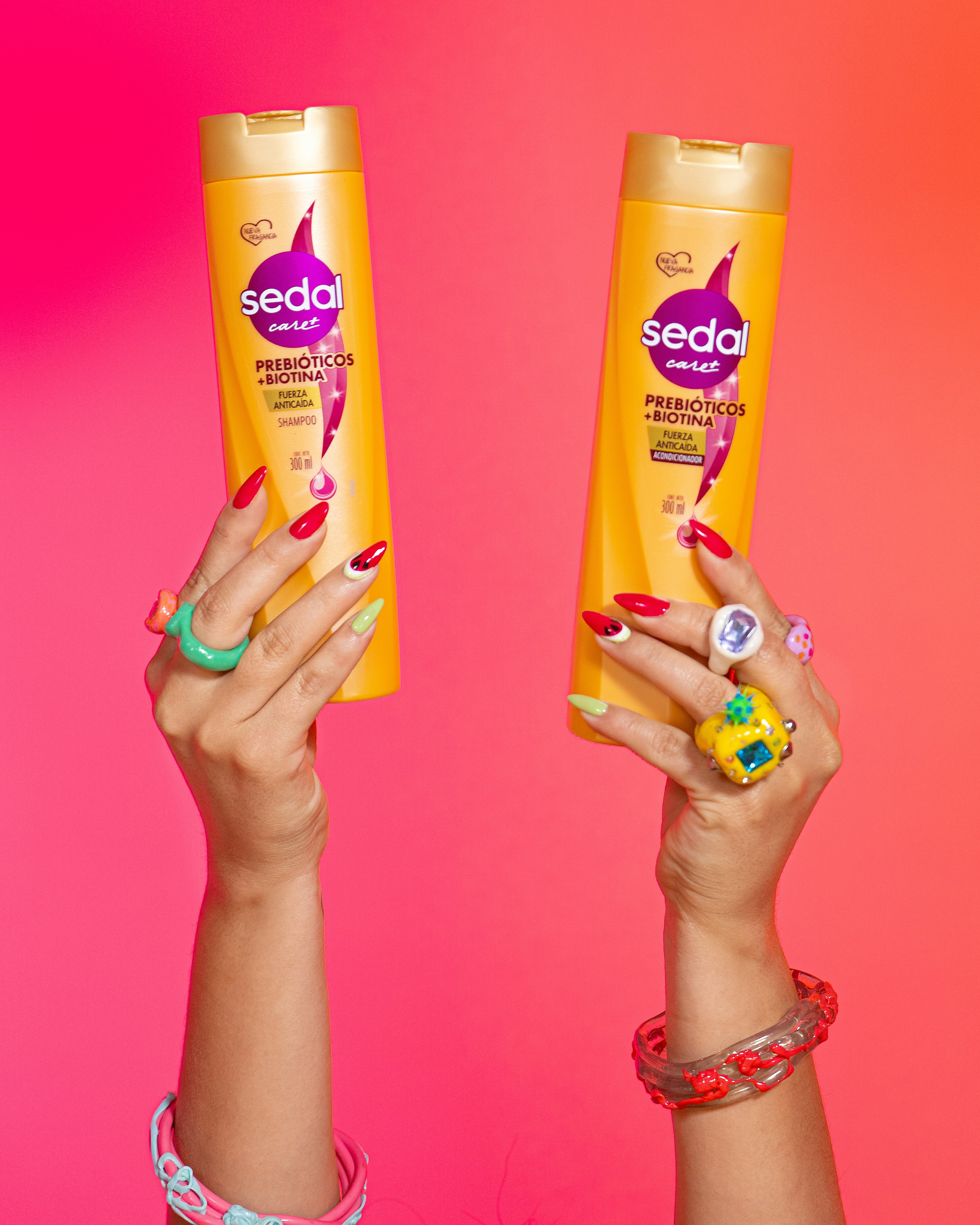 Hands hold two bottles of seda shampoo.