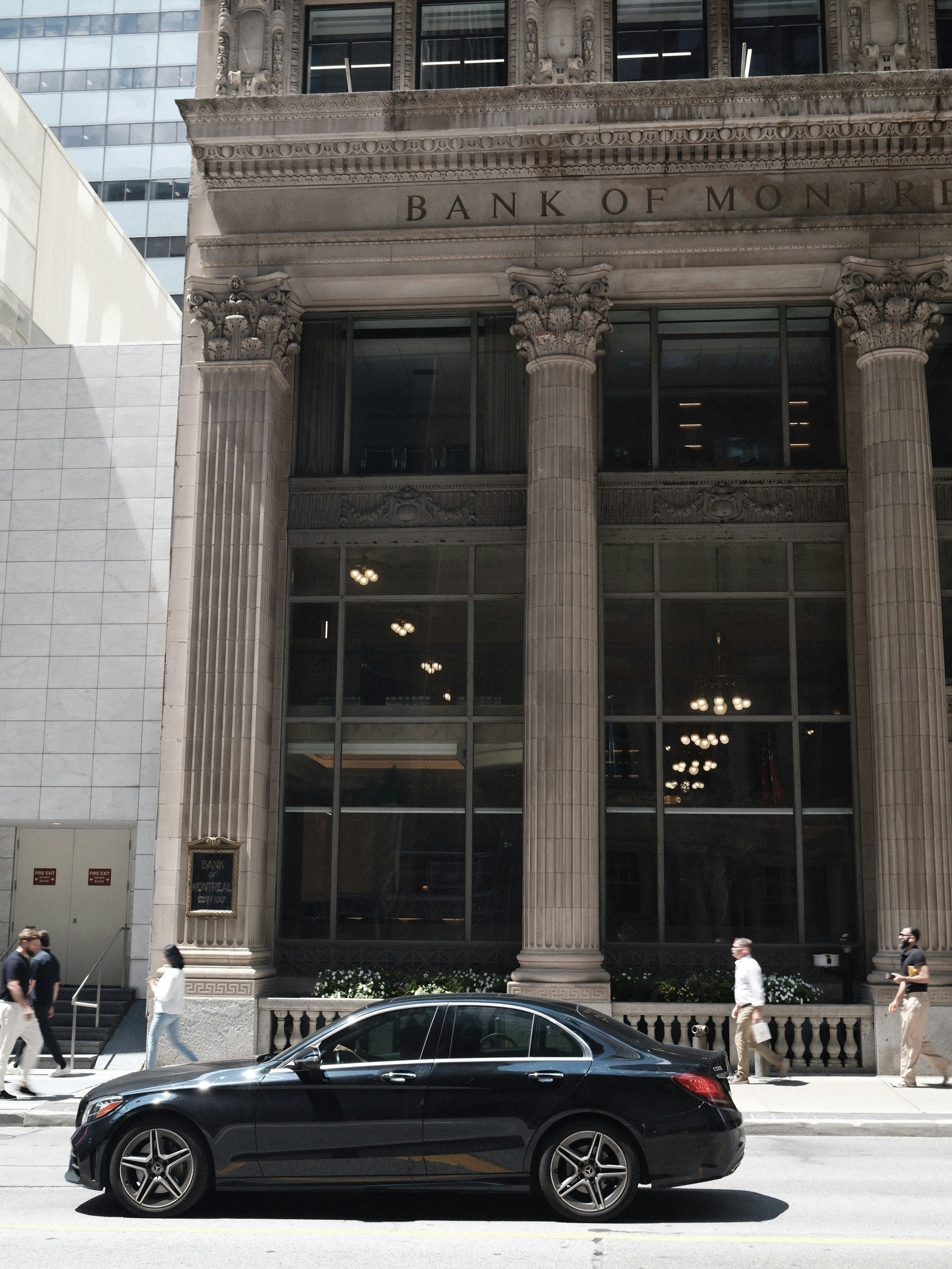 A car drives past the bank of montreal.