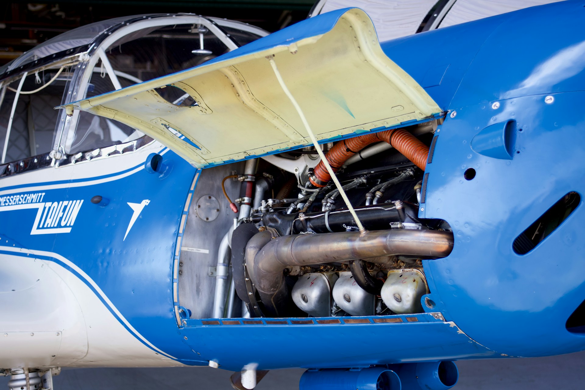 An aircraft engine bay is open for inspection.