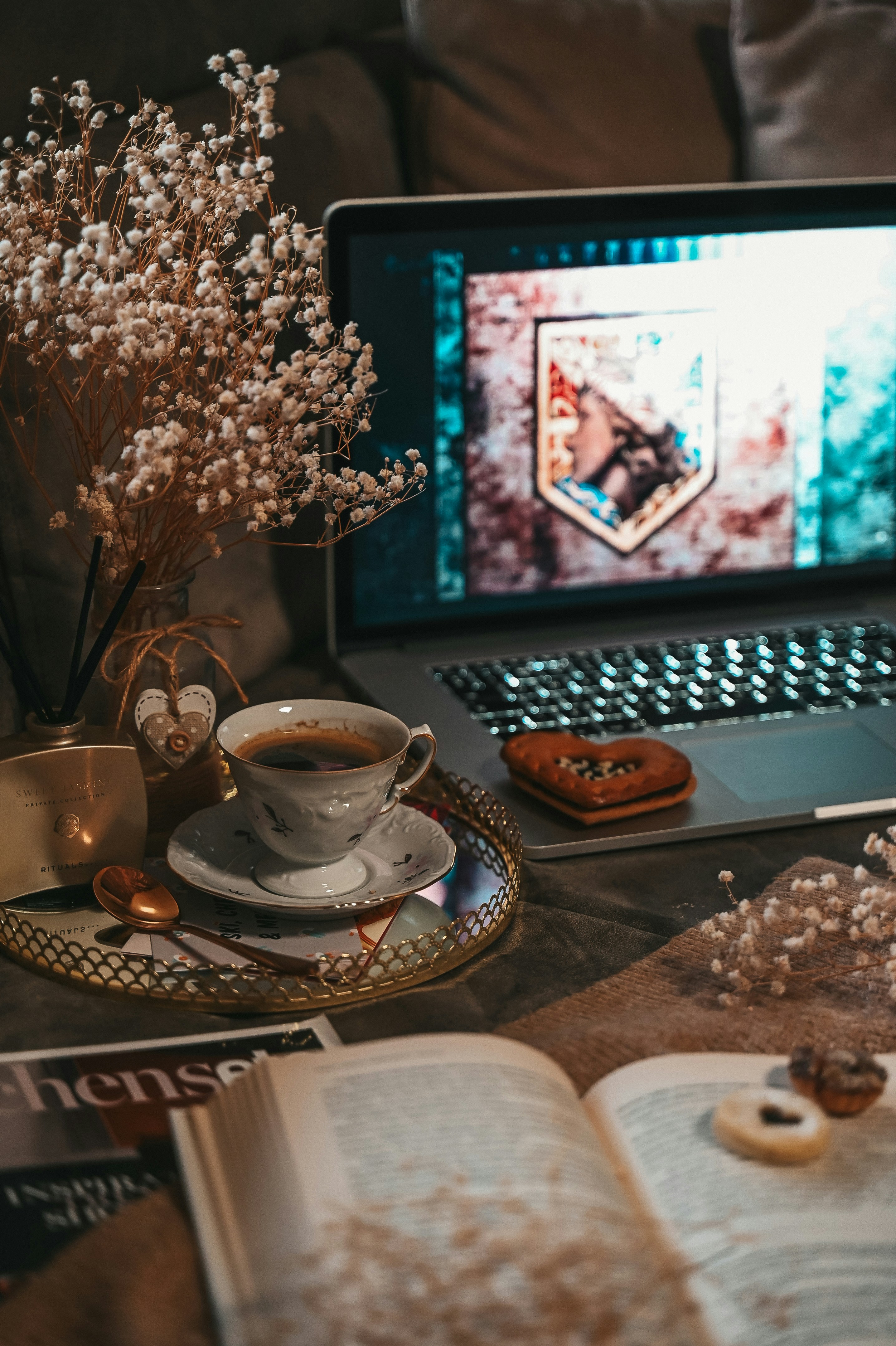 Cozy setup with a laptop, coffee, and snacks.