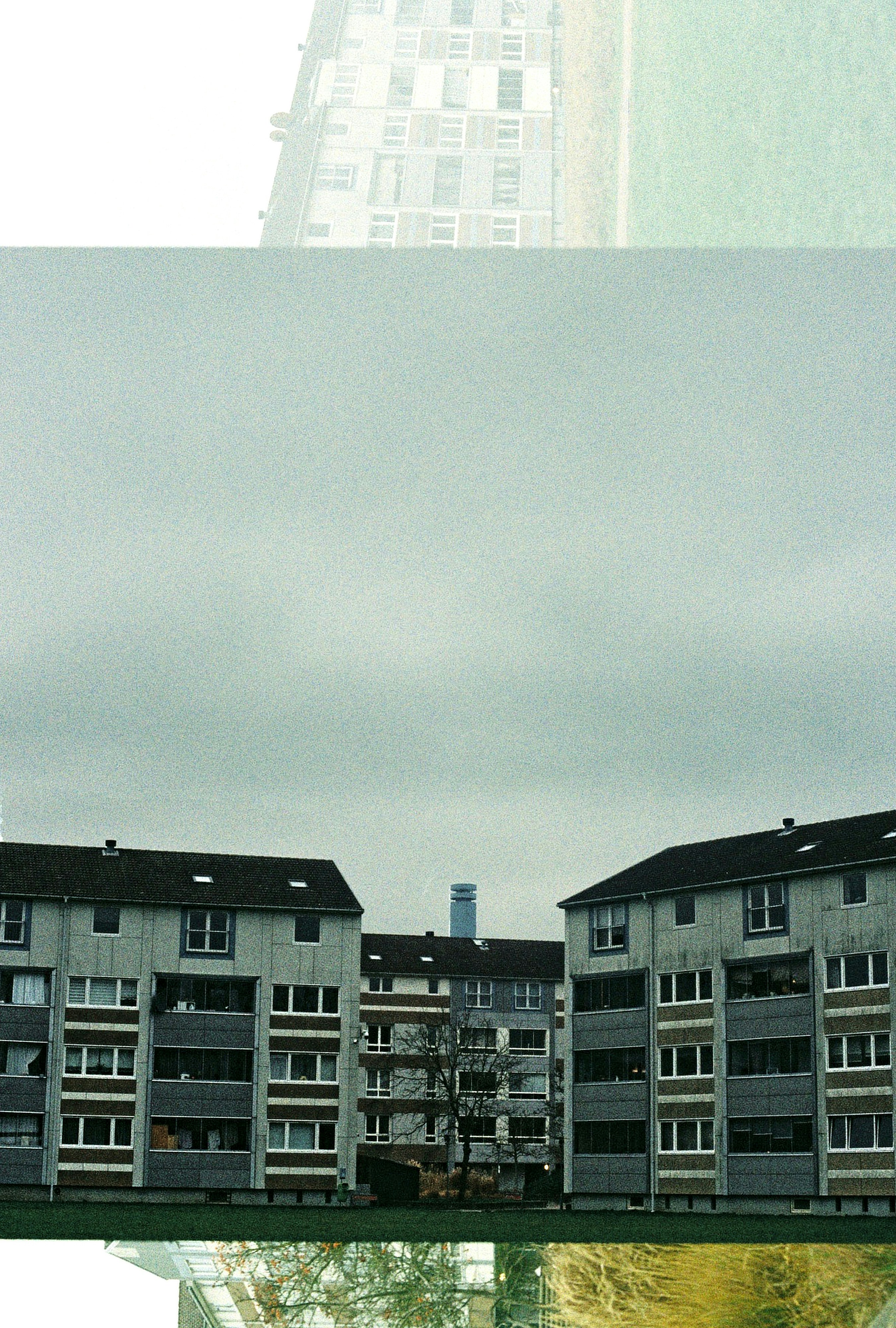 Apartment buildings under a cloudy, gray sky.