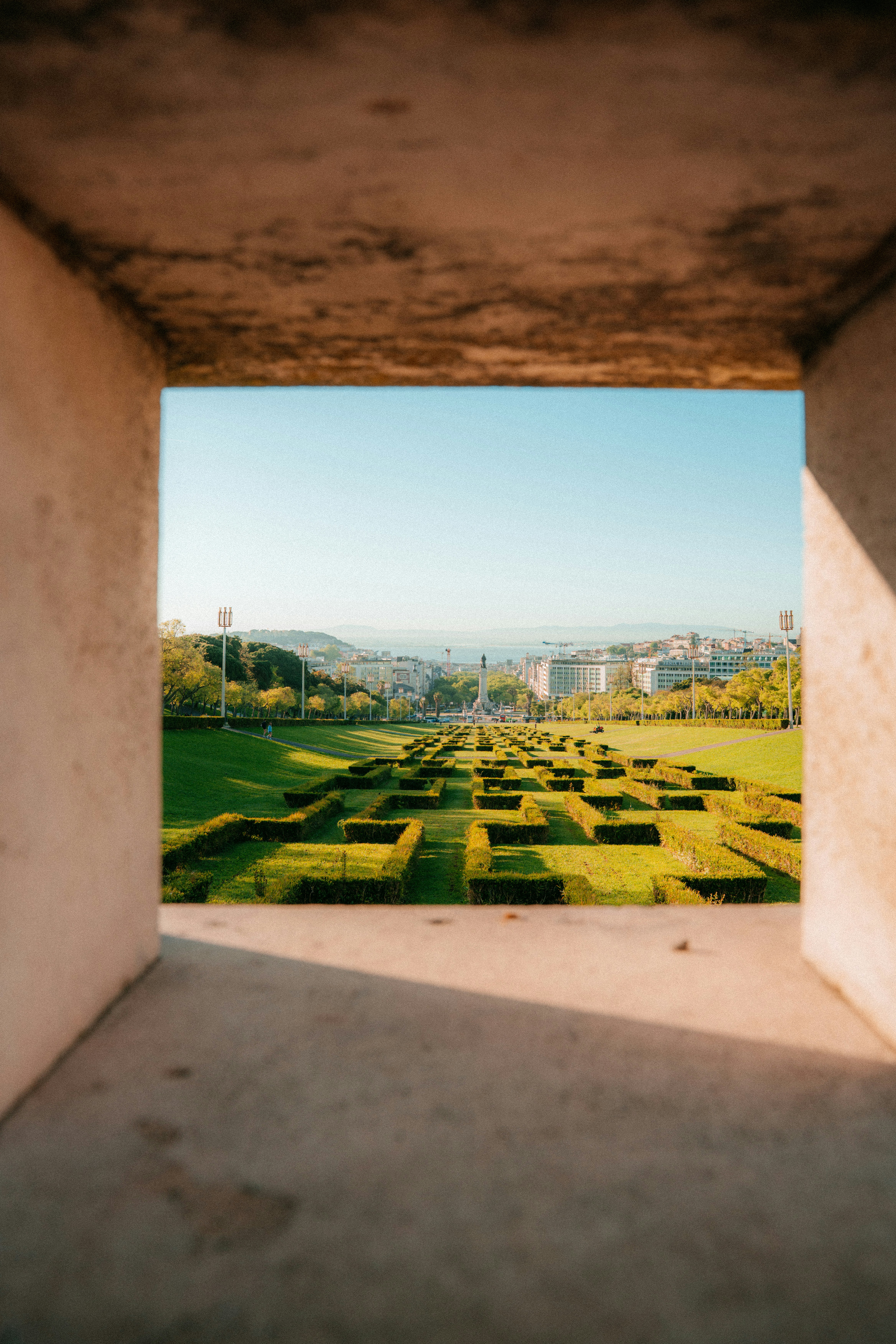 A view of a green landscape framed by concrete.