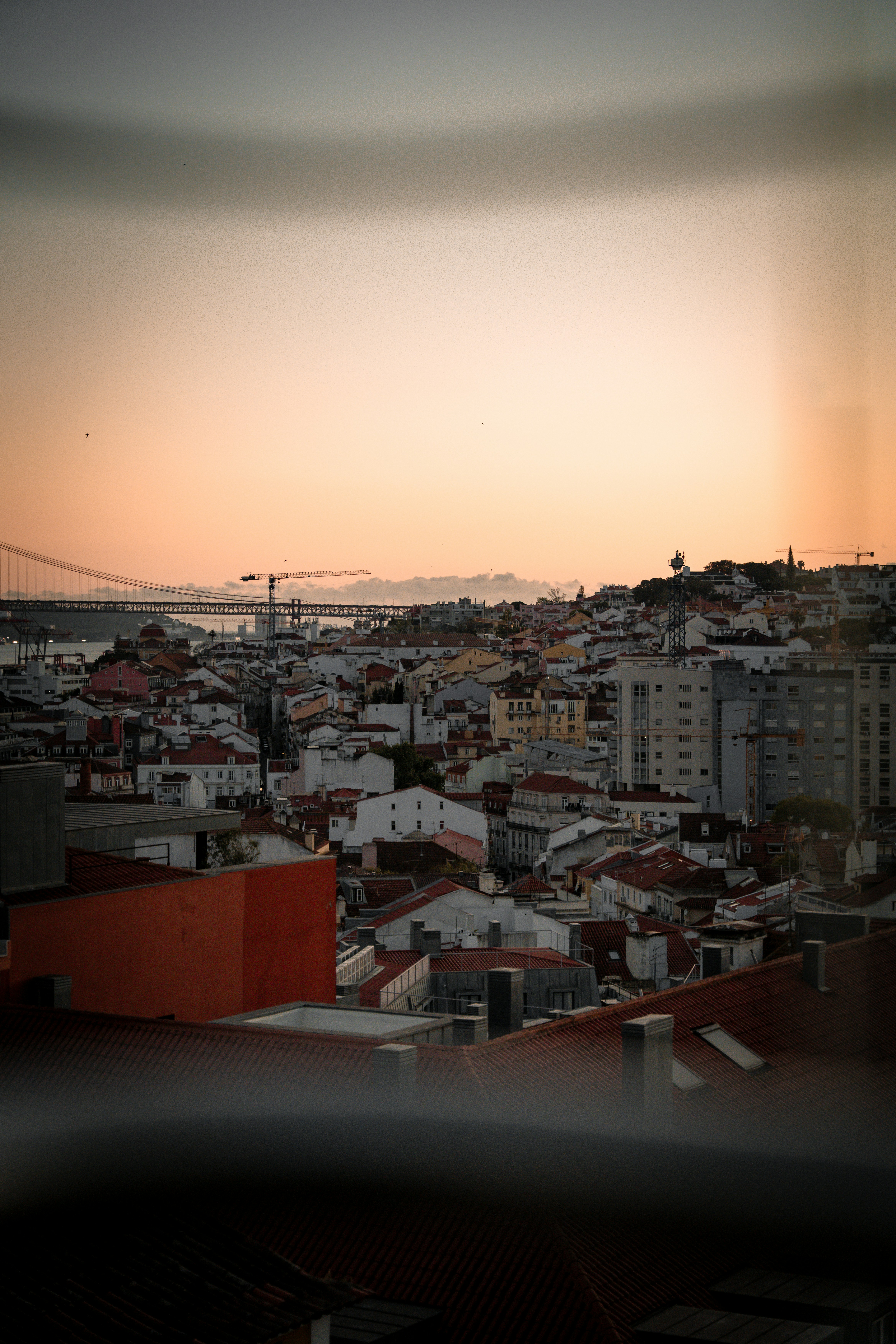 Cityscape view at sunset with a bridge.