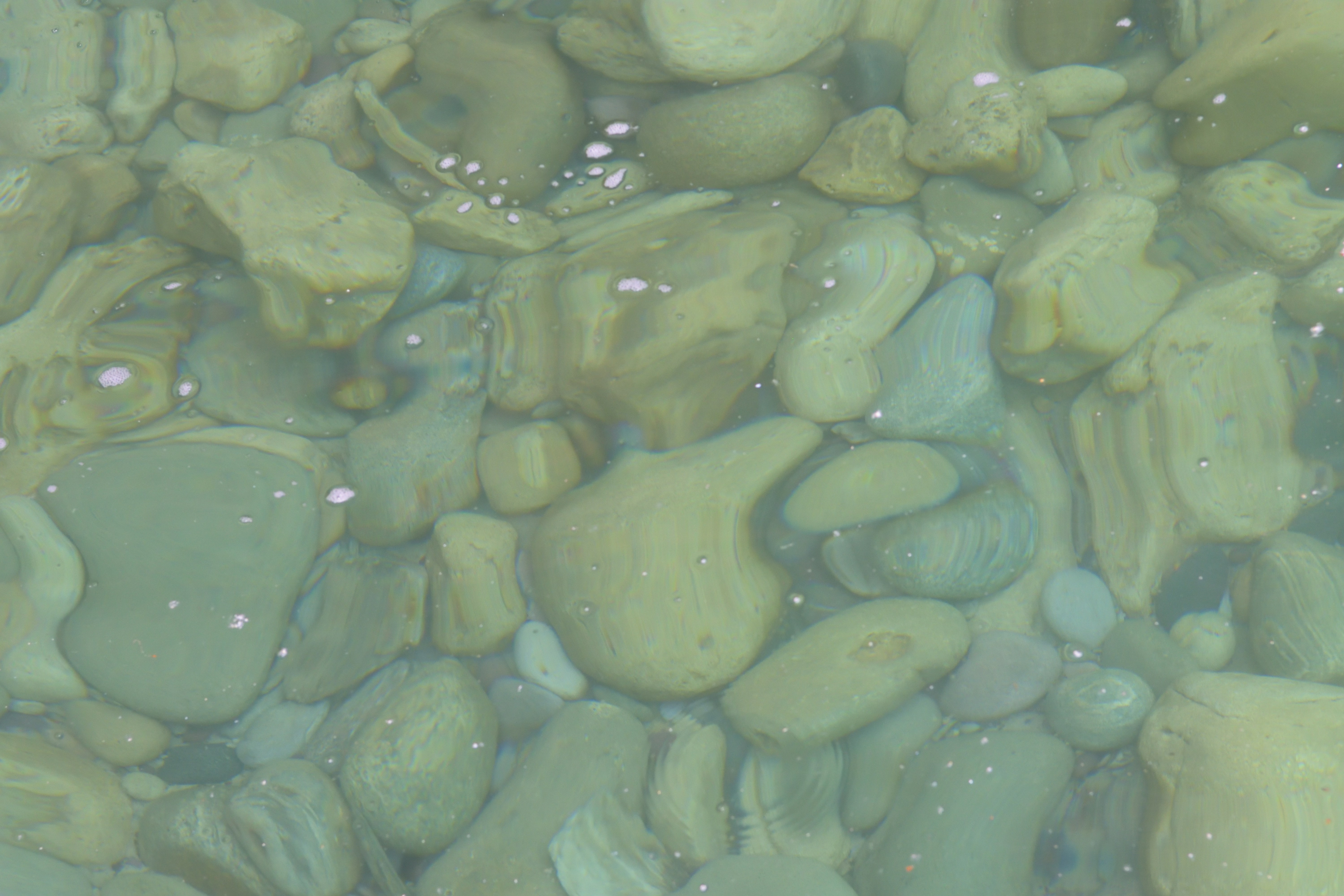 Nature's Jigsaw: The Puzzle Beneath the Surface. How is it that irregular cobbles on the lake bed manage to fit so perfectly? The answer lies in natural sorting, erosion, compaction and post-depositional processes (e.g., biological activity)