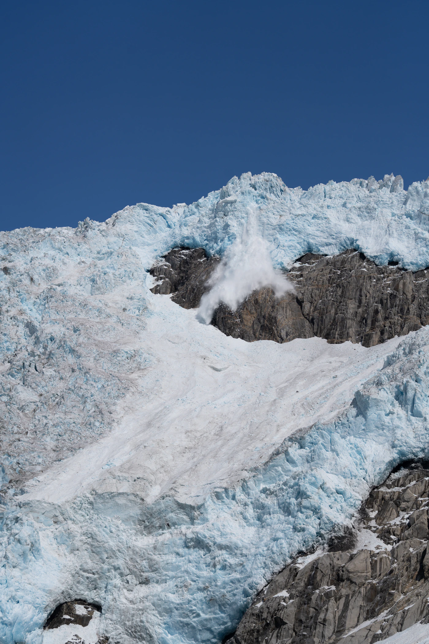 Avalanche moving down a snowy mountain