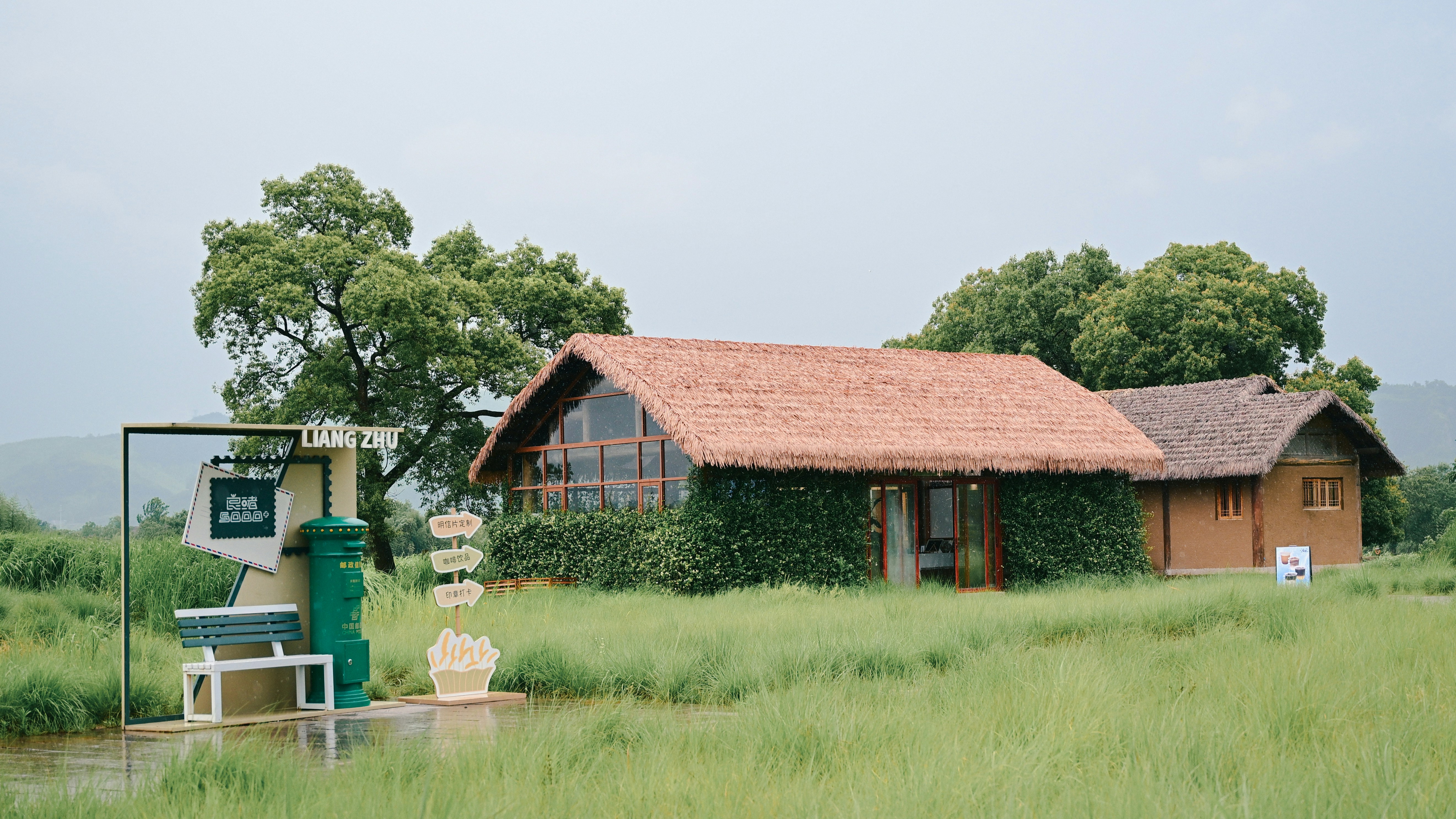 Rustic cabins sit peacefully in a grassy field.