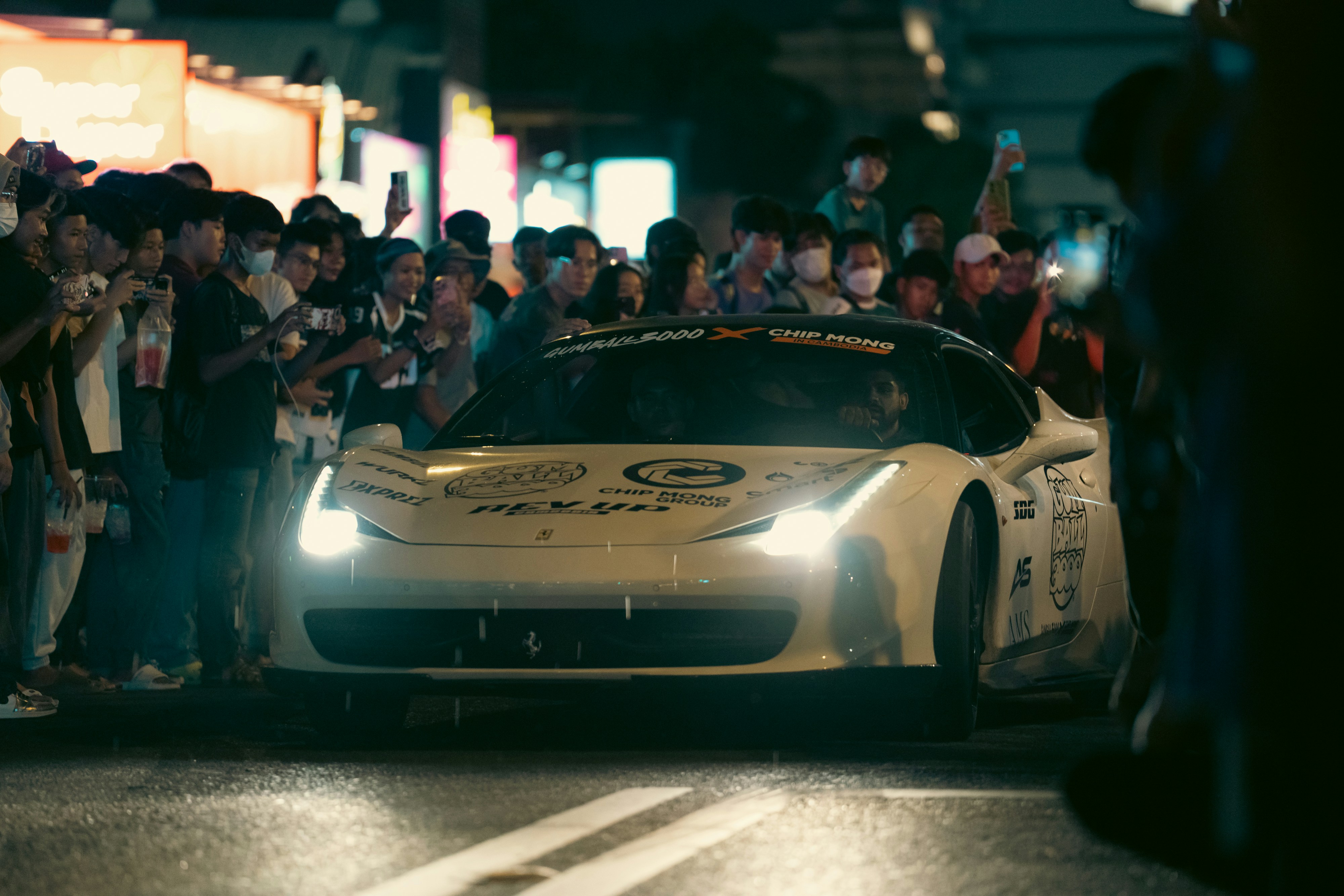 A white sports car is surrounded by a crowd. photo – Free Woman Image ...